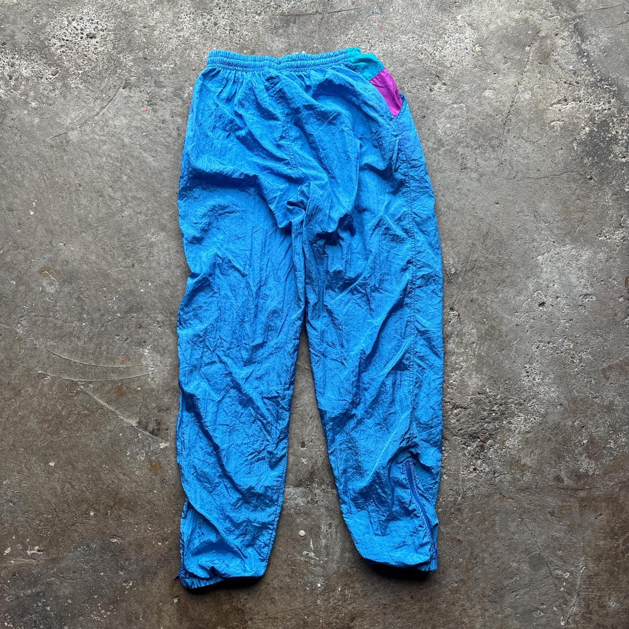 Blue vintage 80s parachute pants with elastic waist and pockets