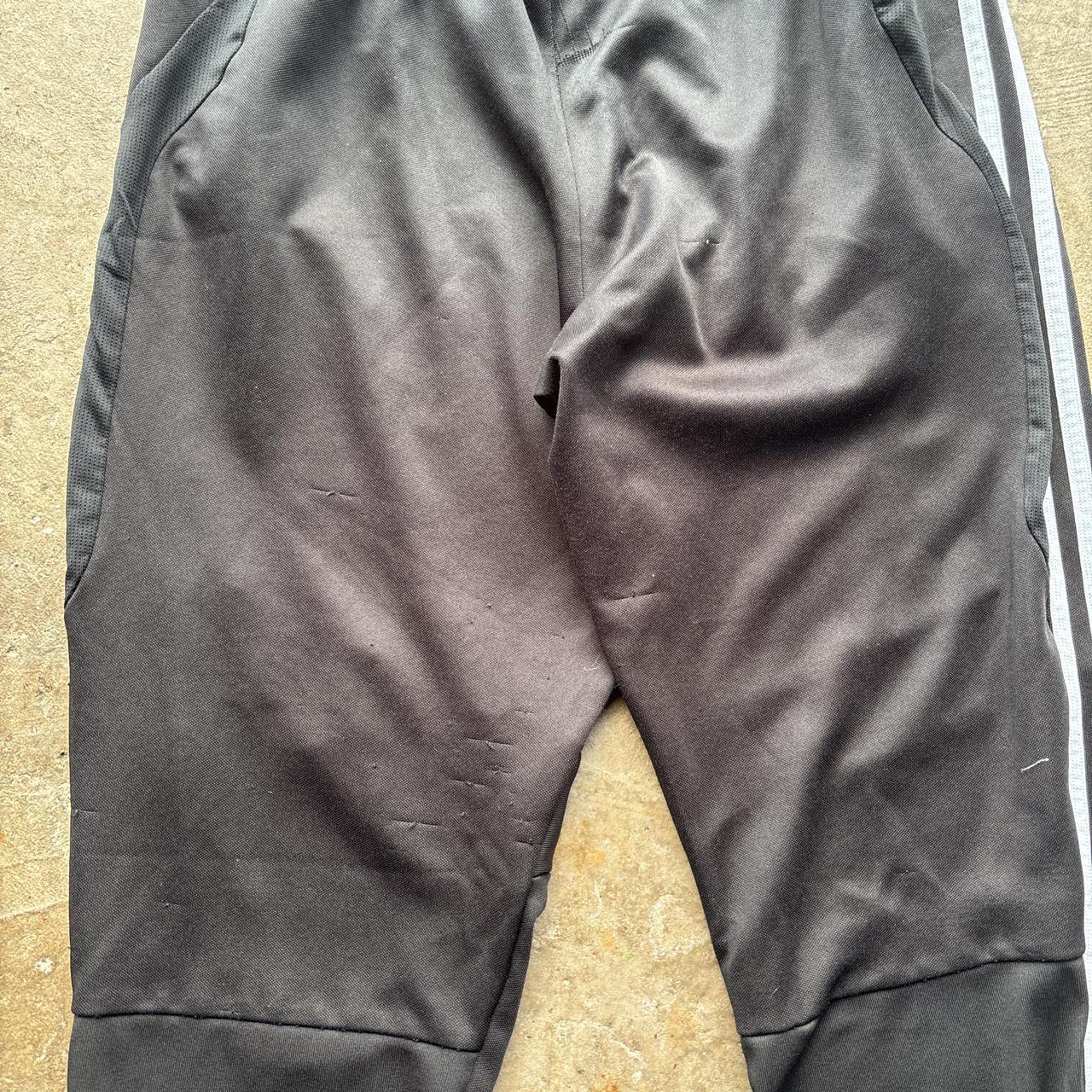 Black Adidas sweatpants with grey stripes and print logo