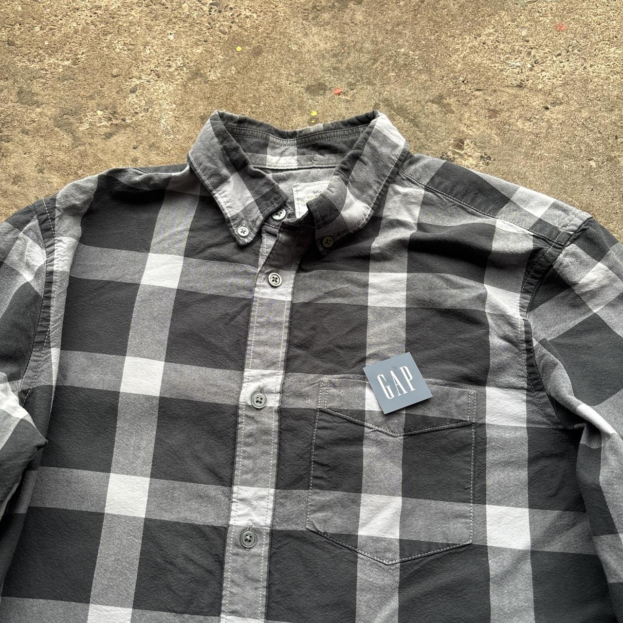 Black and grey Gap Oxford Shirt with workers tag on it