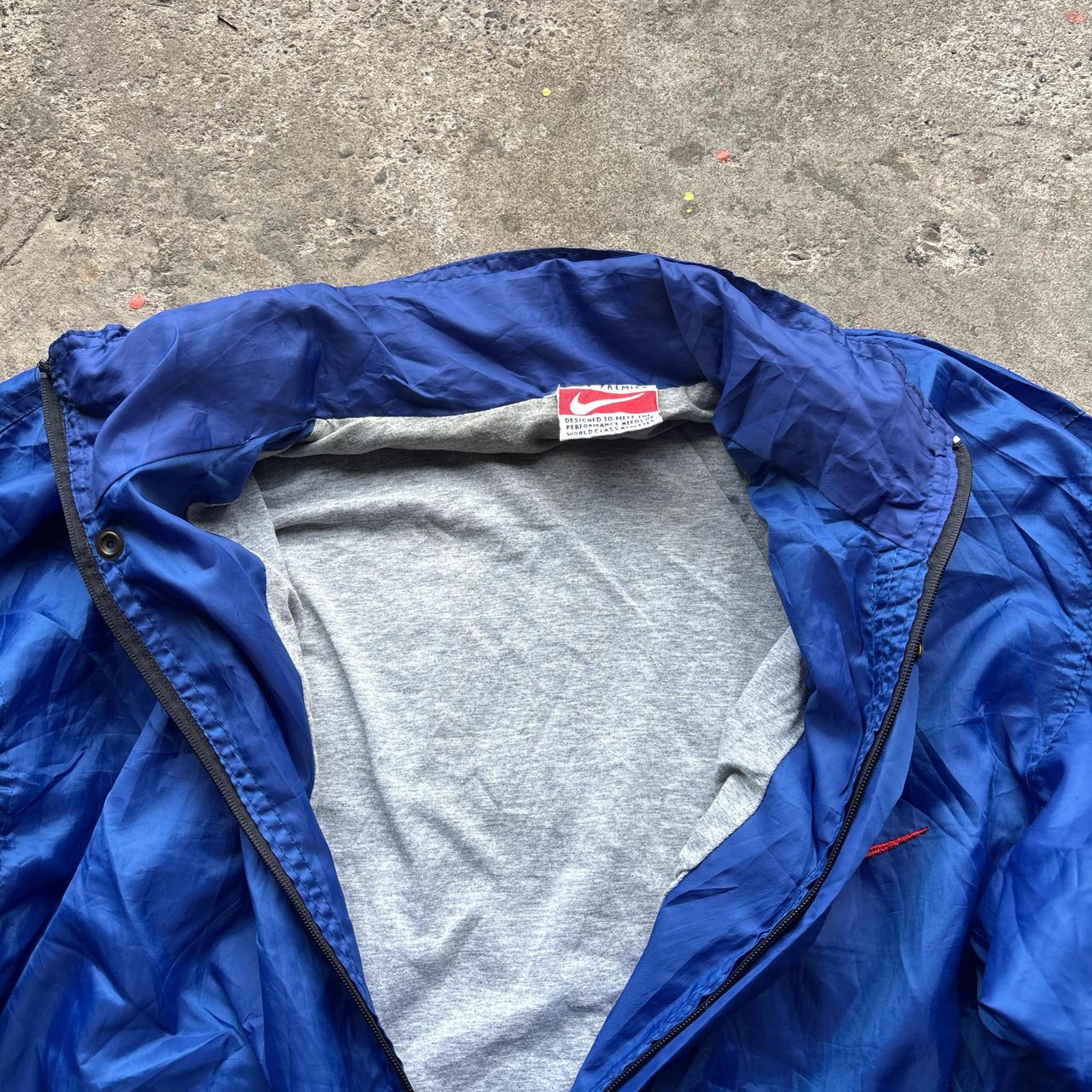 Blue Nike jacket with spell out logo