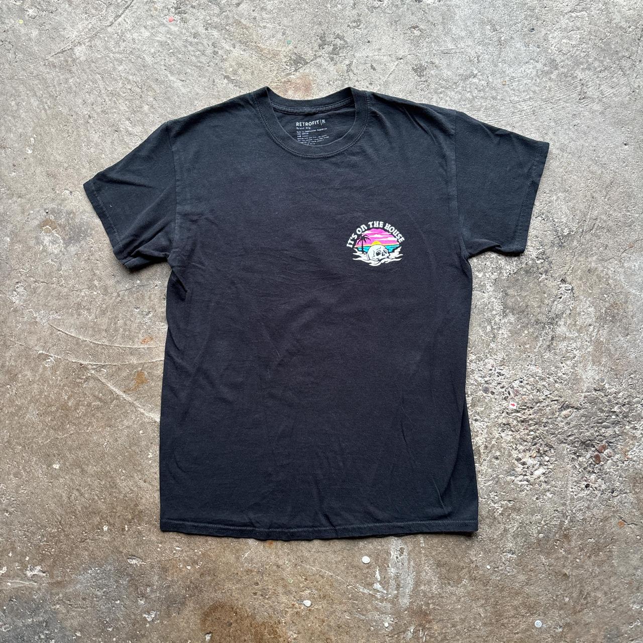 Black graphic tee with ‘it’s on the house’ graphic