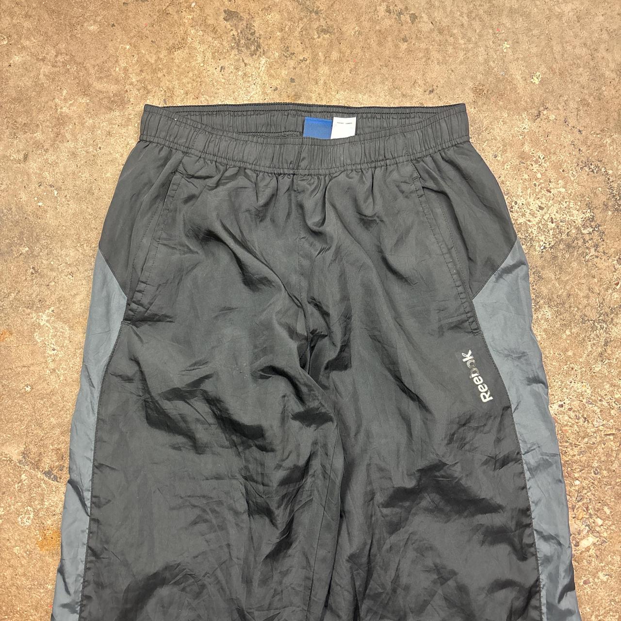 Black and grey Reebok track pants