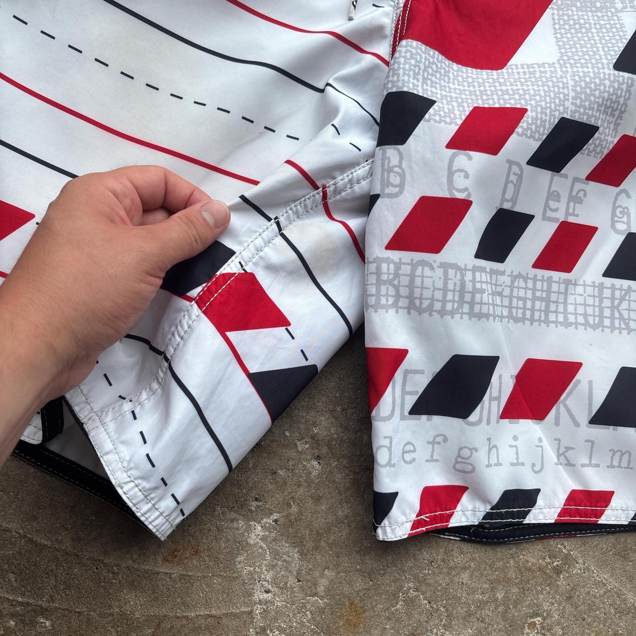 White, red and black 00s Quicksilver Dane Reynolds Board Shorts