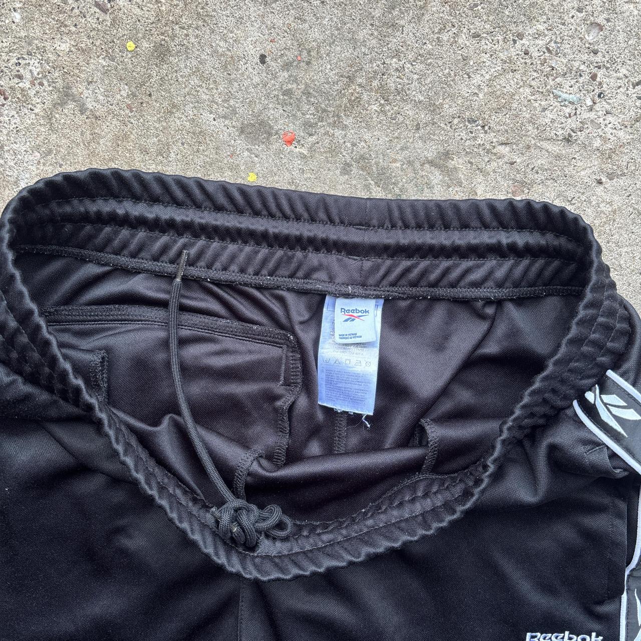 Reebok black joggers with repeat logo stripe