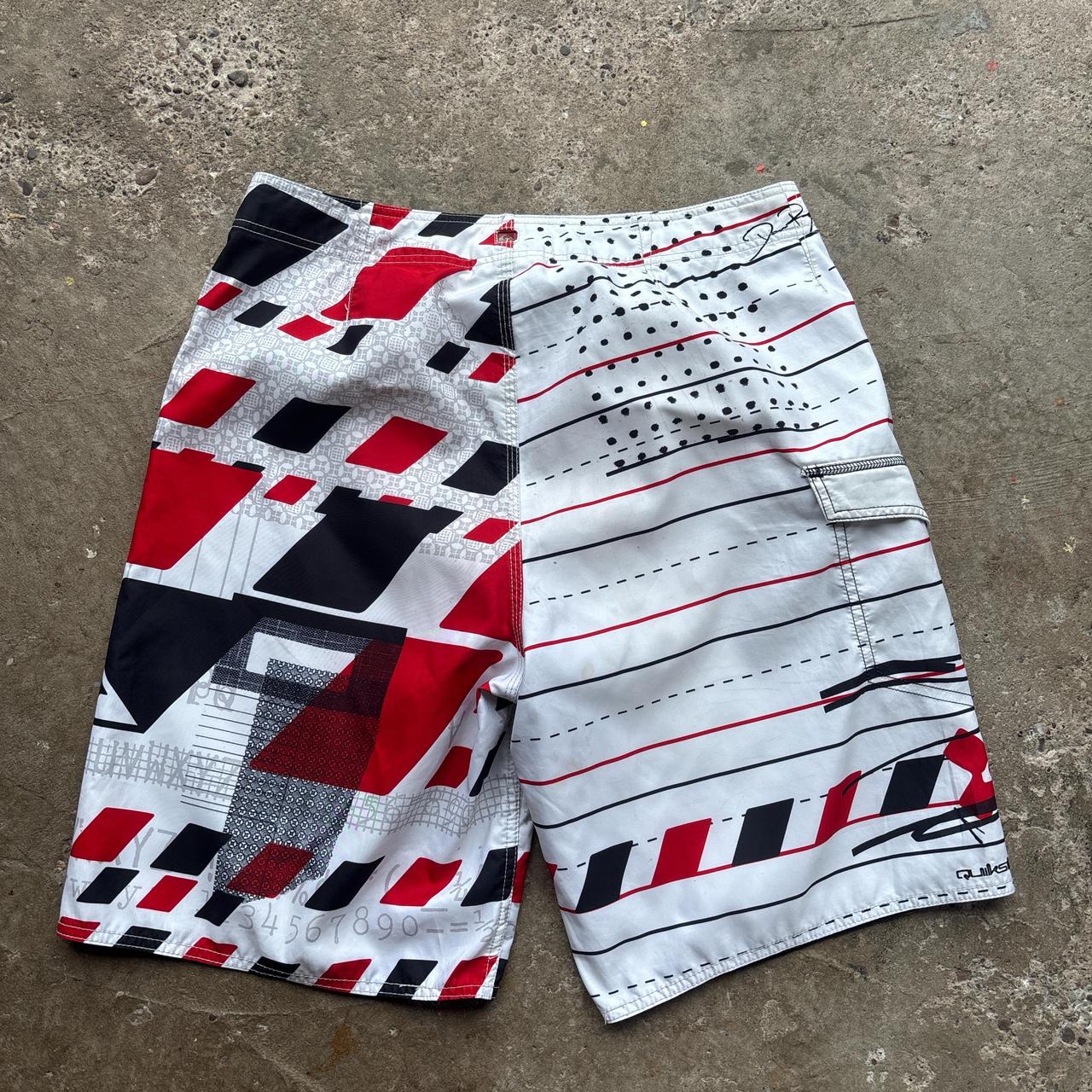 White, red and black 00s Quicksilver Dane Reynolds Board Shorts