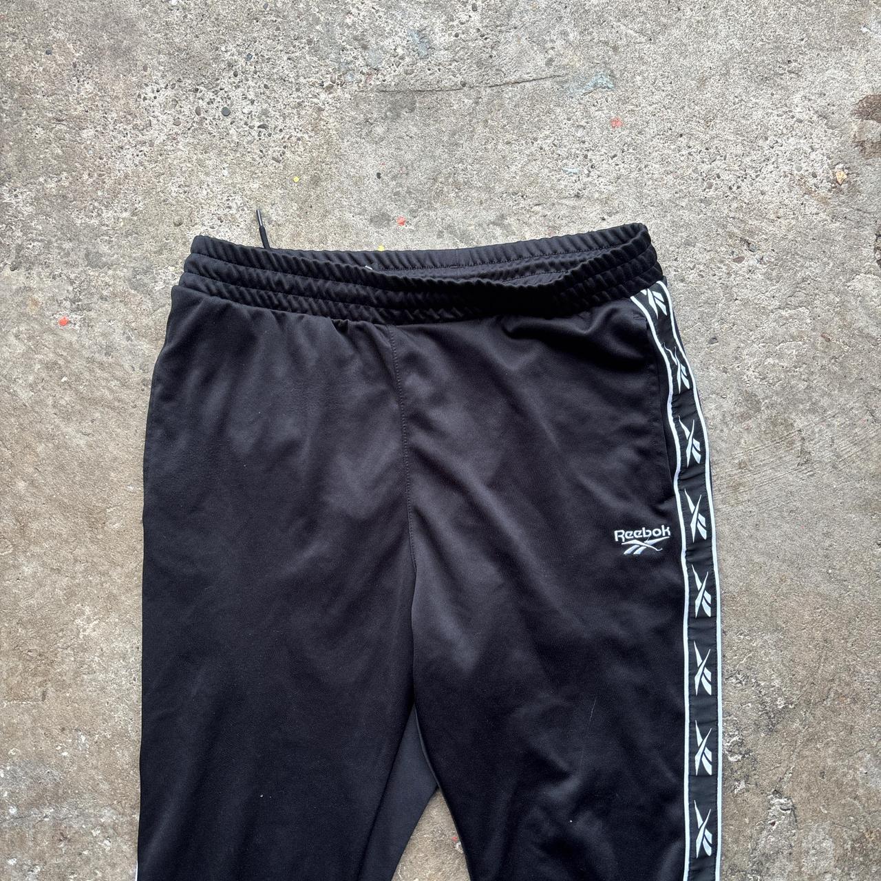 Reebok black joggers with repeat logo stripe