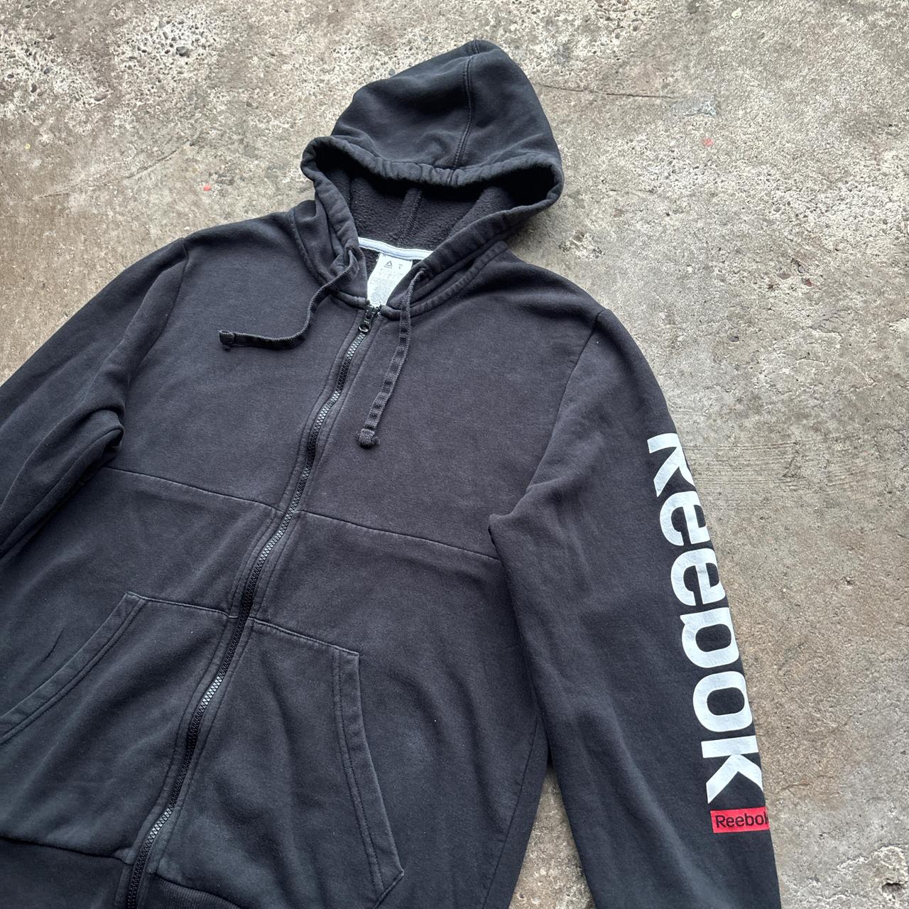 Black Reebok zip-up hoody with spell out logo