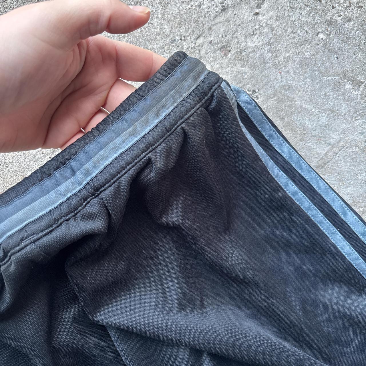 Black Adidas sweatpants with grey stripes and print logo