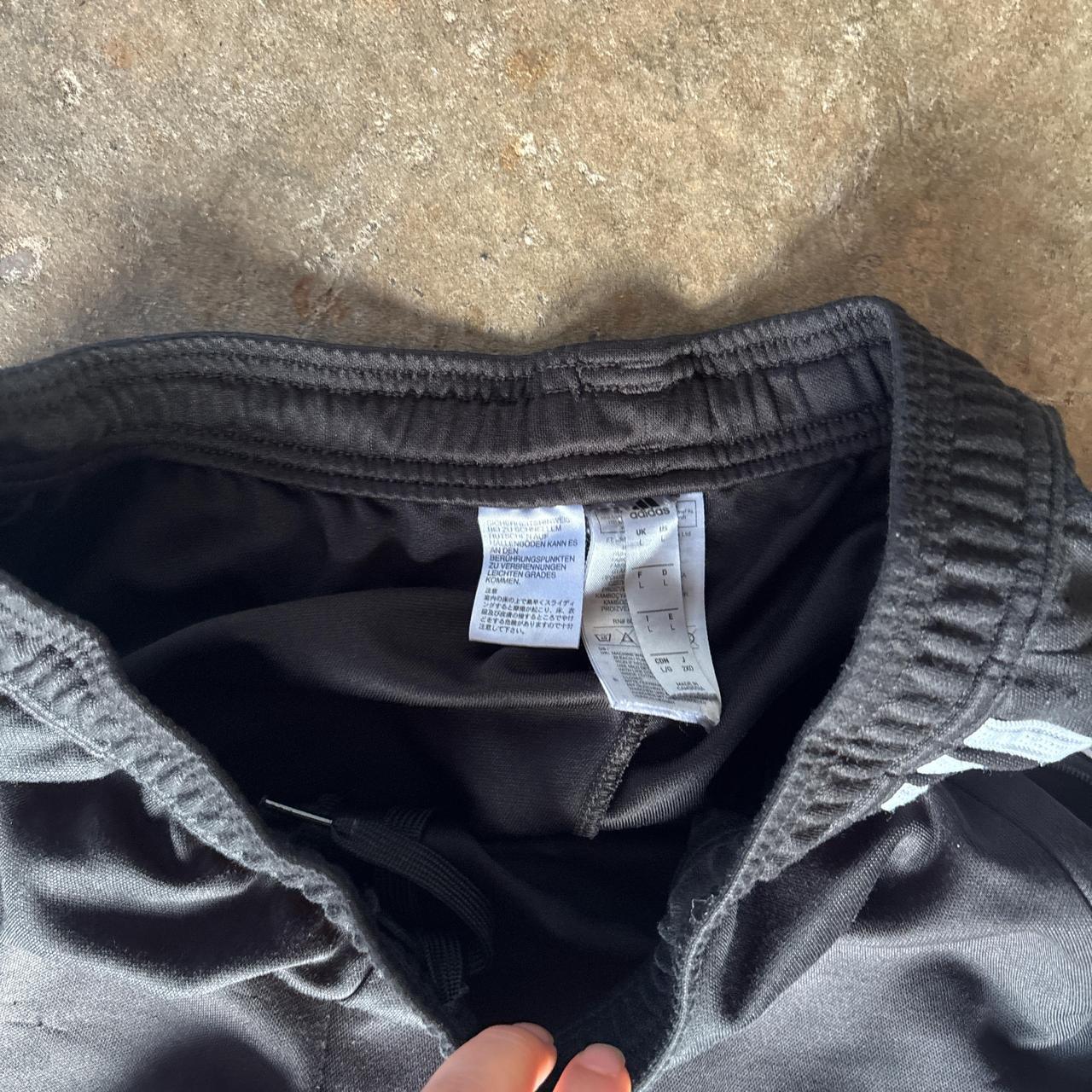 Black Adidas sweatpants with grey stripes and print logo