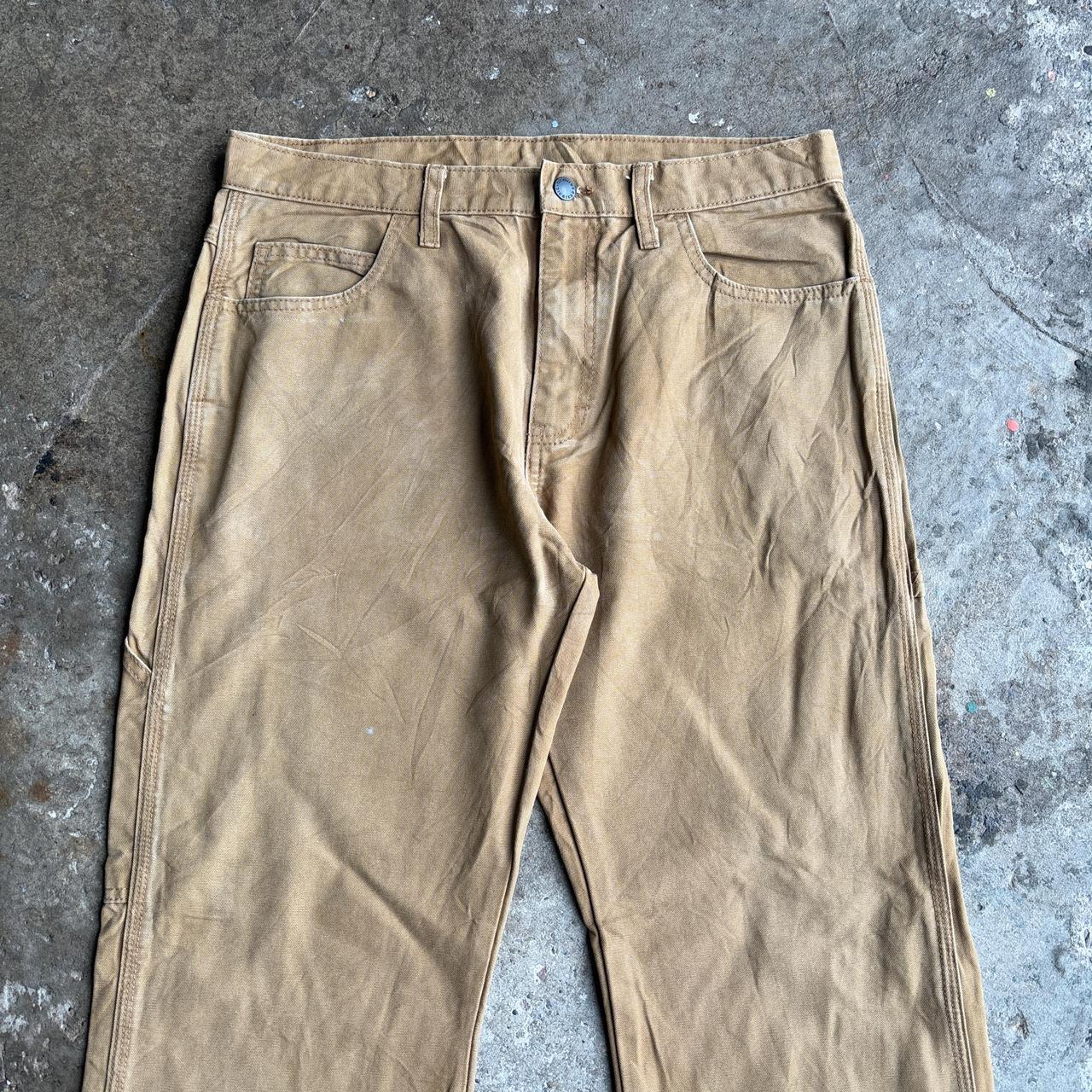 Tan Dickies straight leg carpenters pants with a relaxed fit
