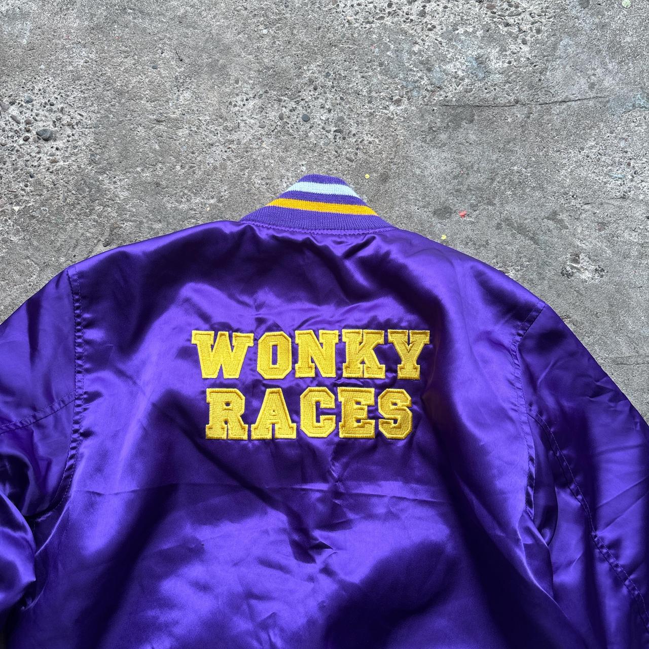 Purple bomber jacket with ‘Wonky Races’ embroidered design at the back