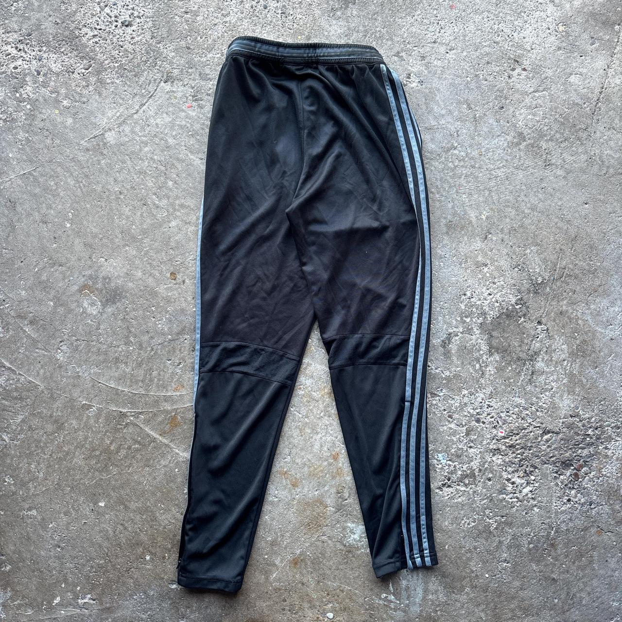Black Adidas sweatpants with grey stripes and print logo