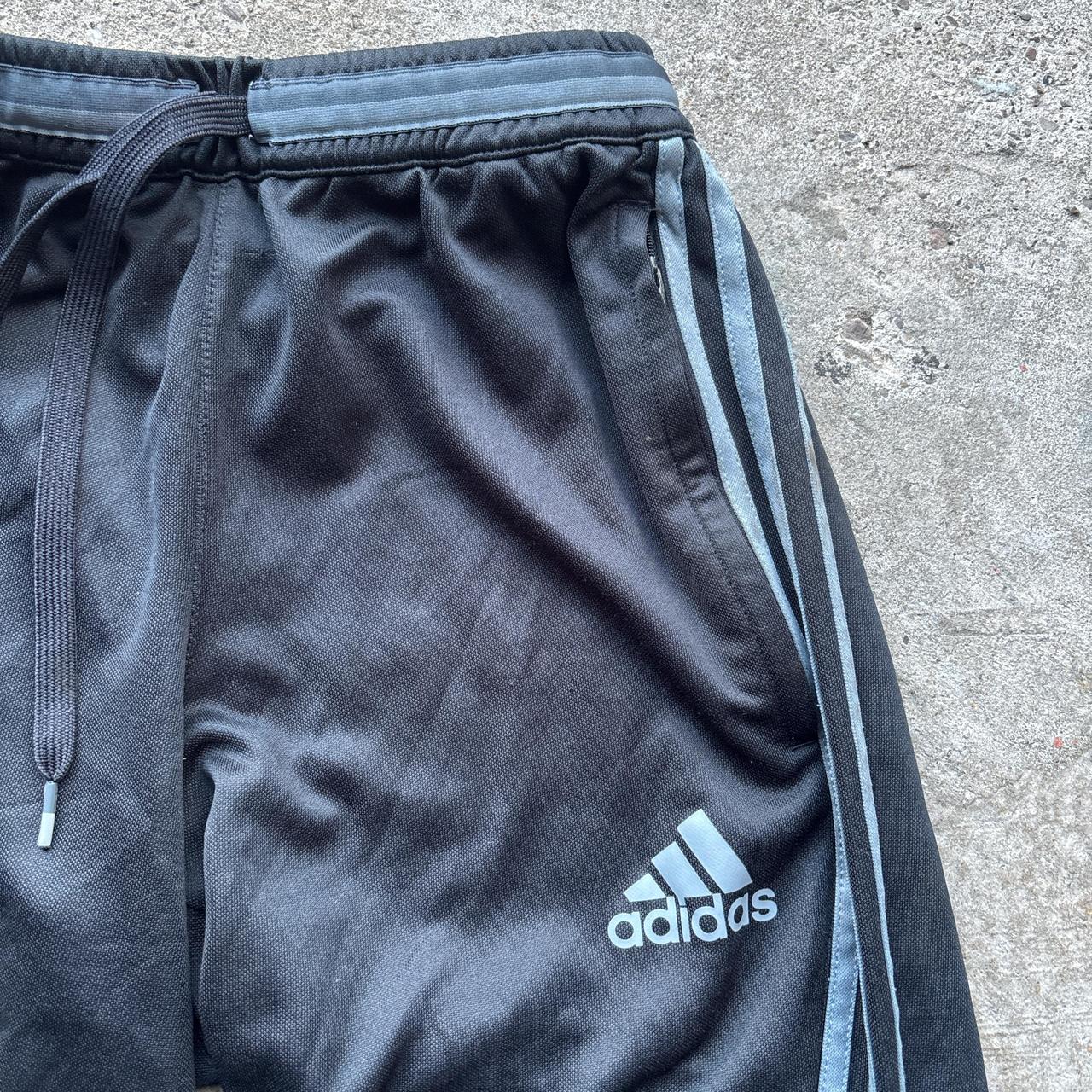 Black Adidas sweatpants with grey stripes and print logo