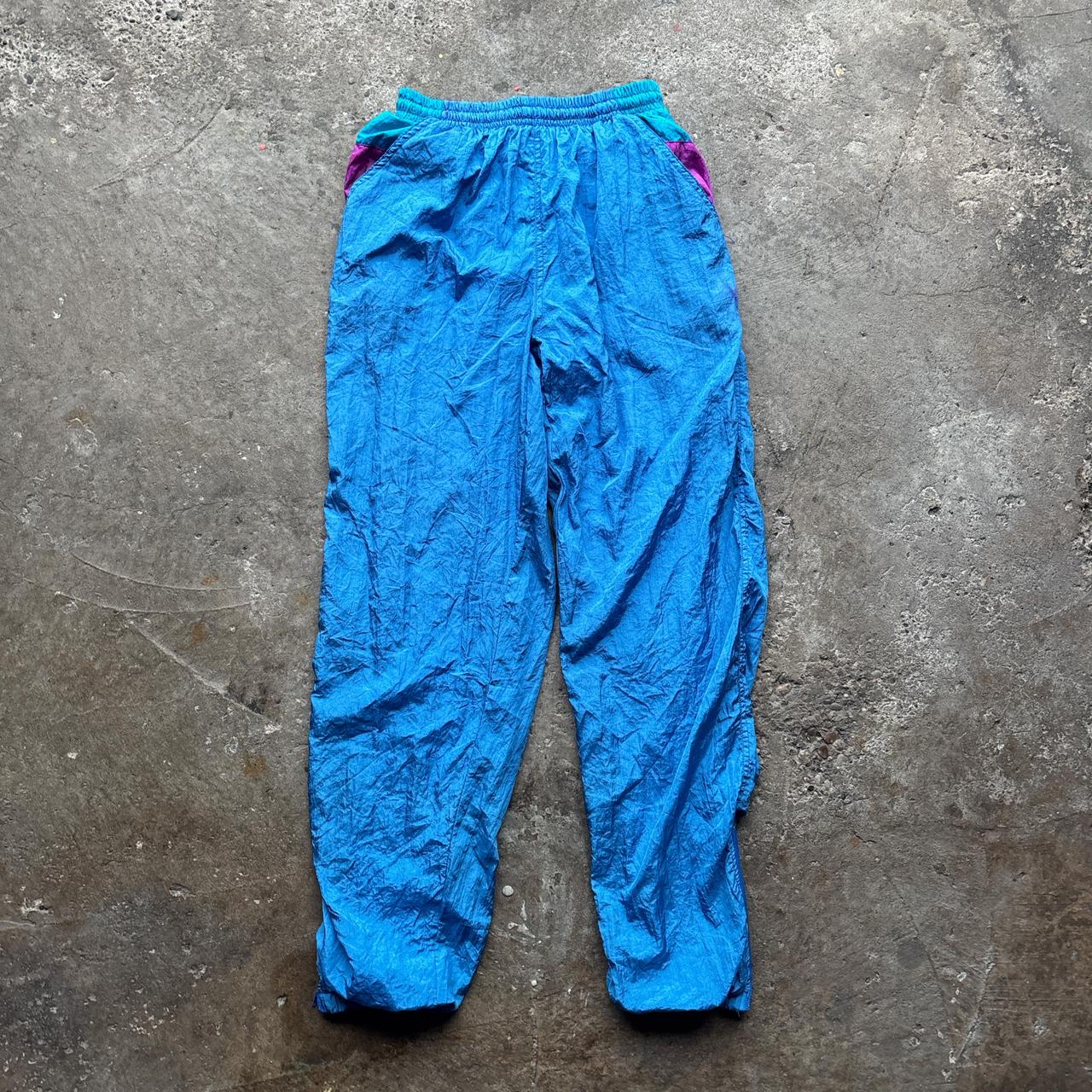 Blue vintage 80s parachute pants with elastic waist and pockets