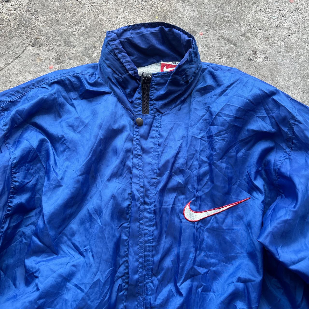 Blue Nike jacket with spell out logo