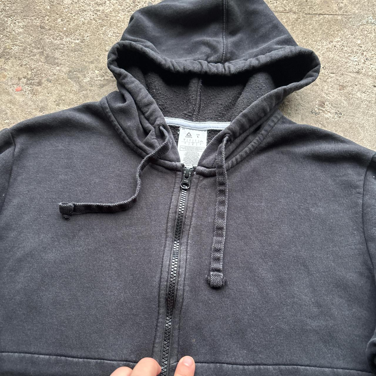 Black Reebok zip-up hoody with spell out logo