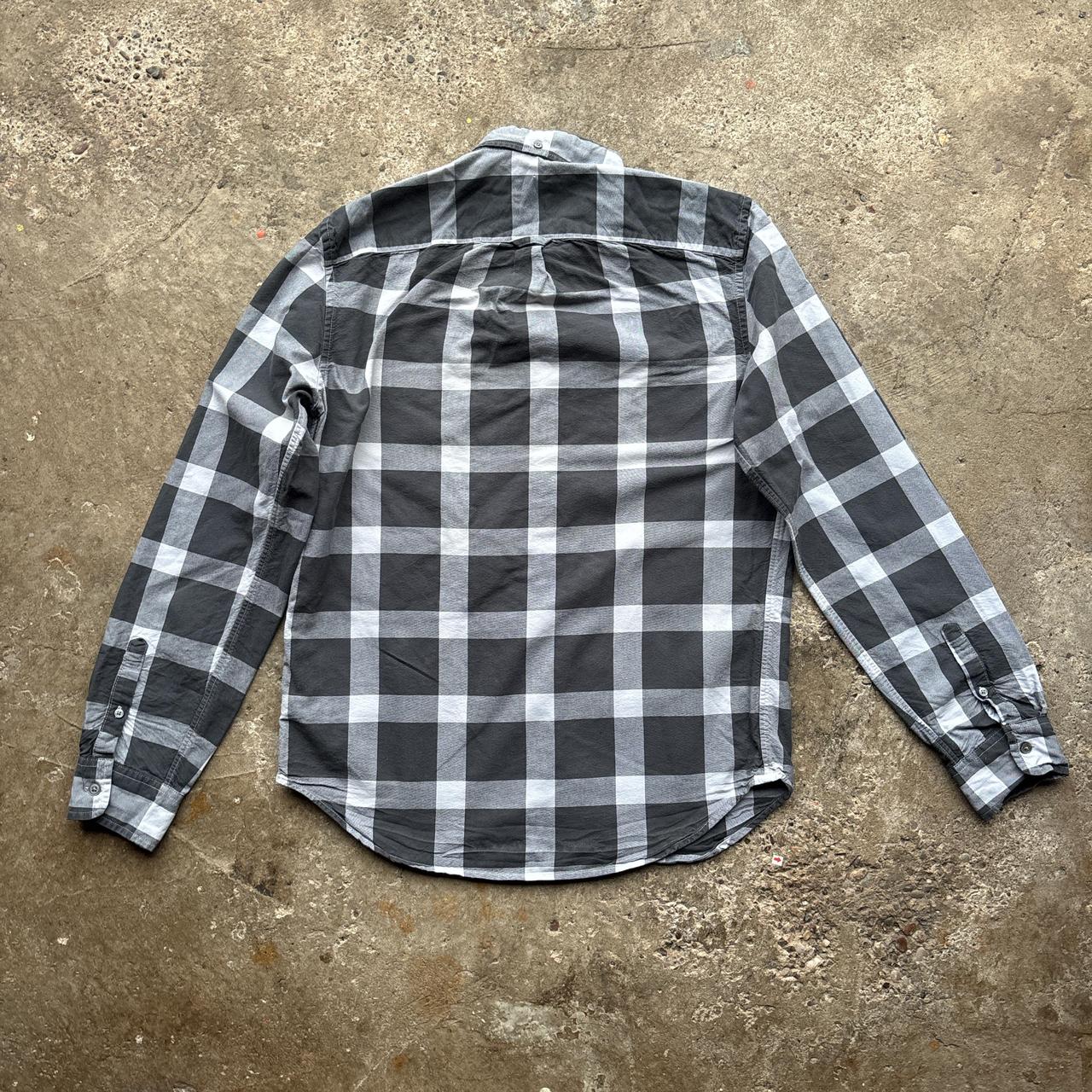 Black and grey Gap Oxford Shirt with workers tag on it