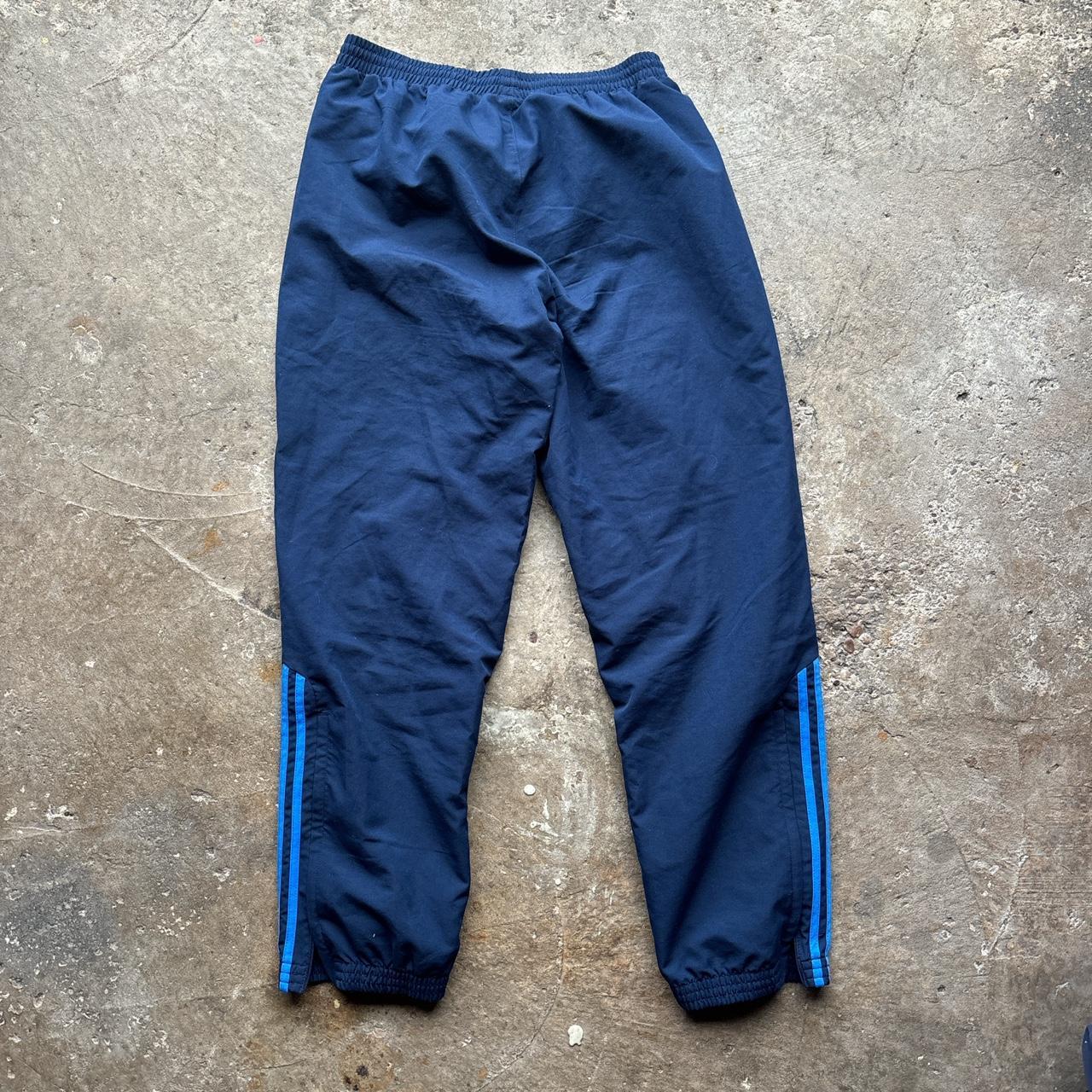 Navy Adidas track pants with blue stripes and embroidered logo