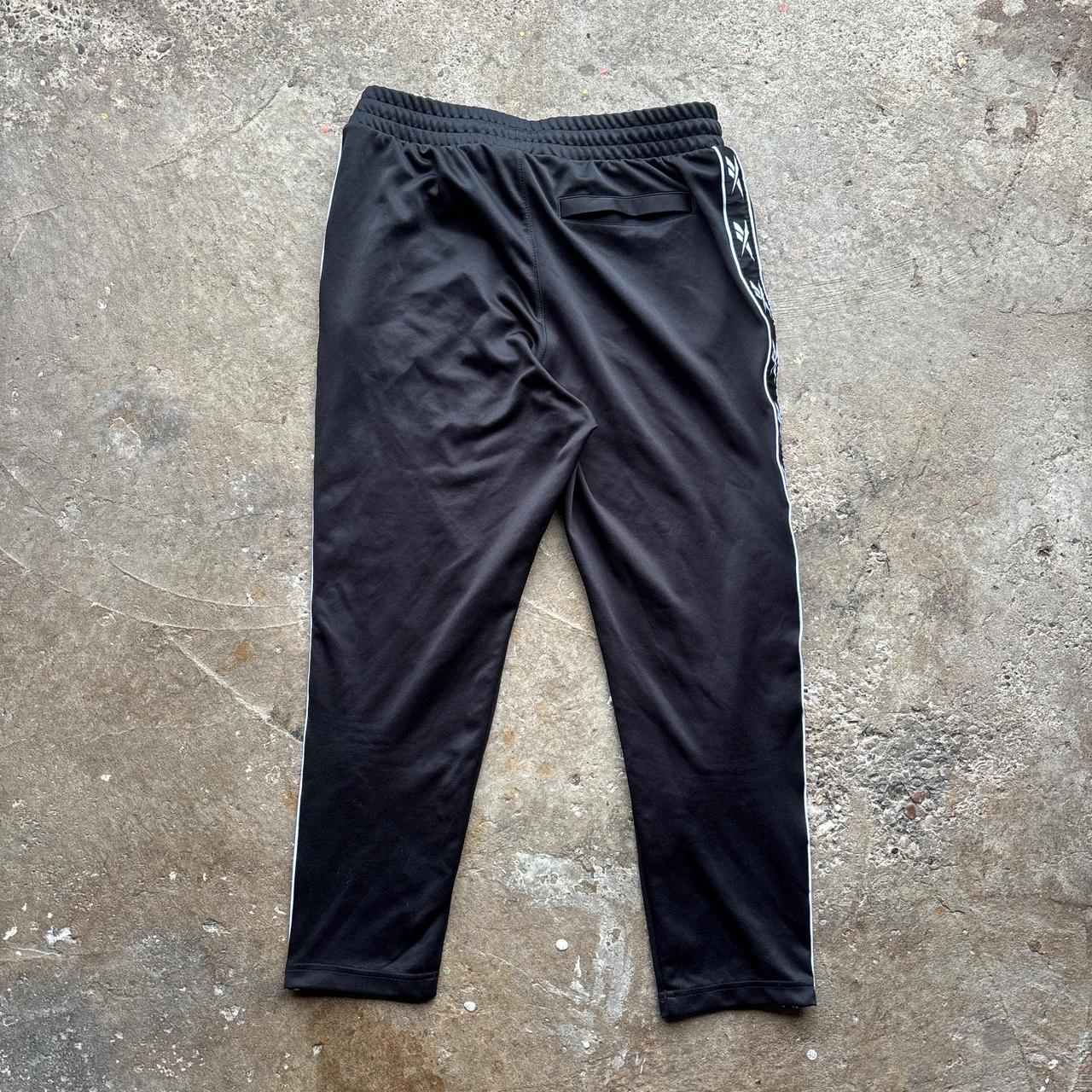 Reebok black joggers with repeat logo stripe