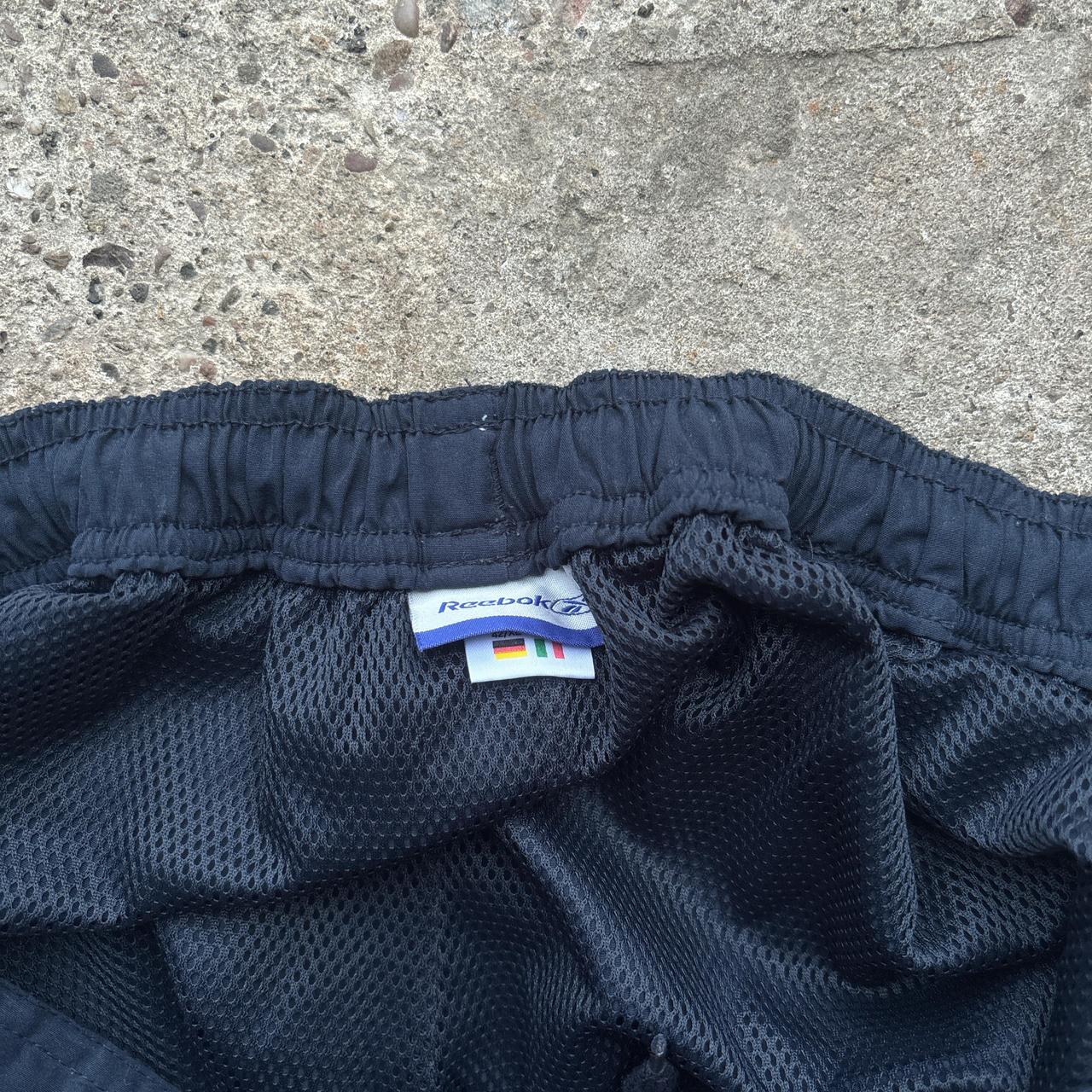 Navy blue Reebok sweatpants with embroidered logo