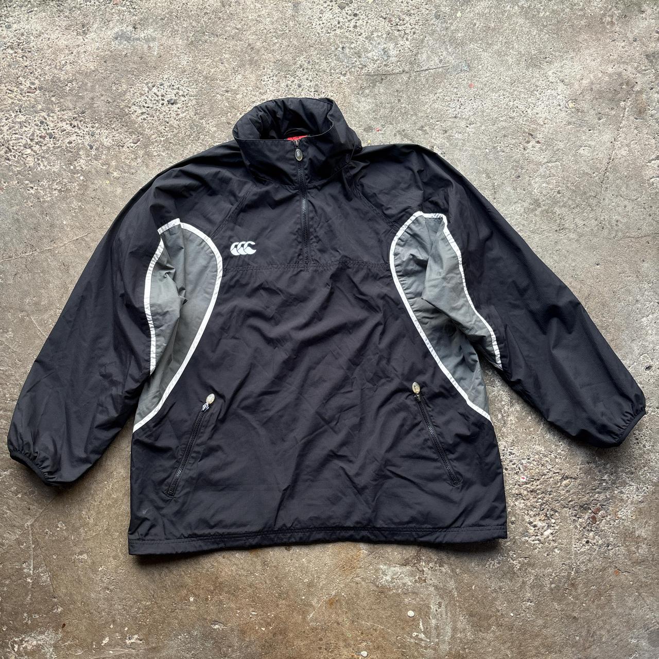 Black and grey Canterbury quarter zip windbreaker