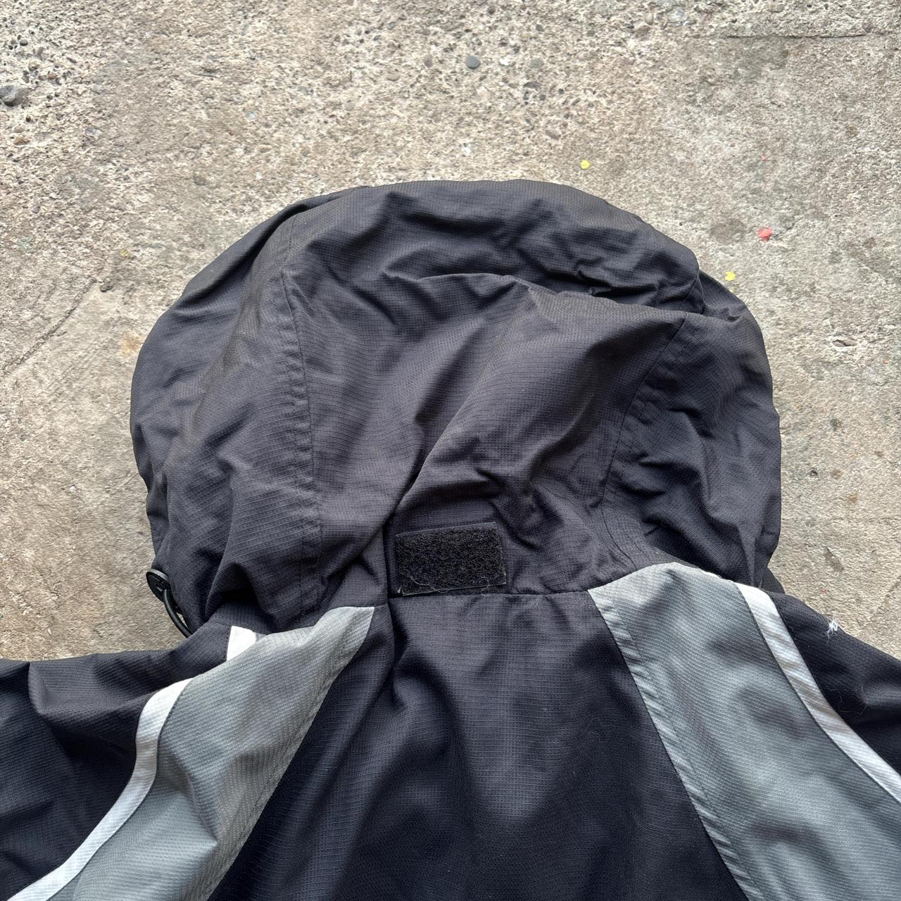 Black and grey Canterbury quarter zip windbreaker