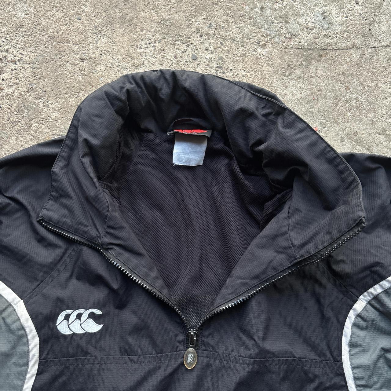 Black and grey Canterbury quarter zip windbreaker