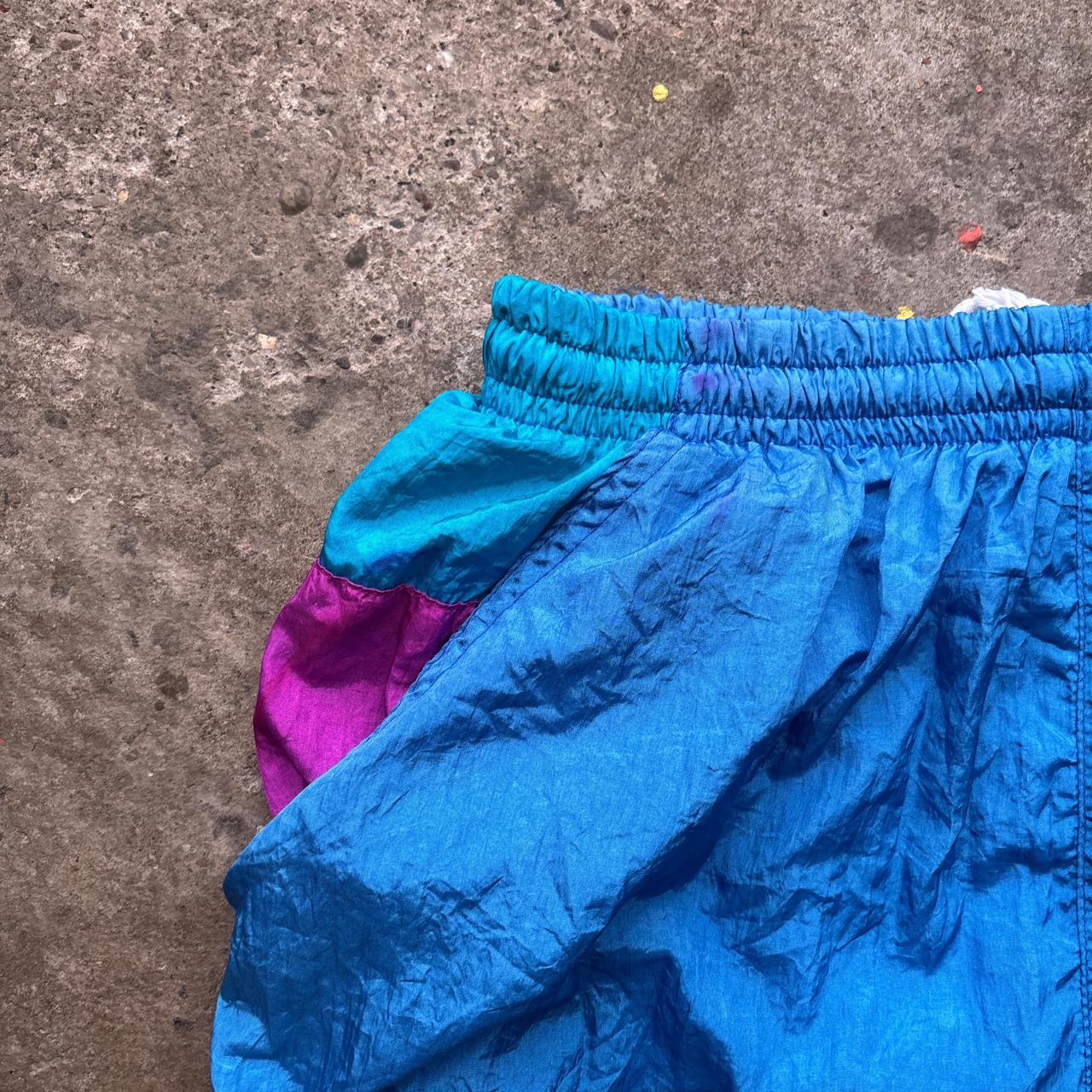 Blue vintage 80s parachute pants with elastic waist and pockets