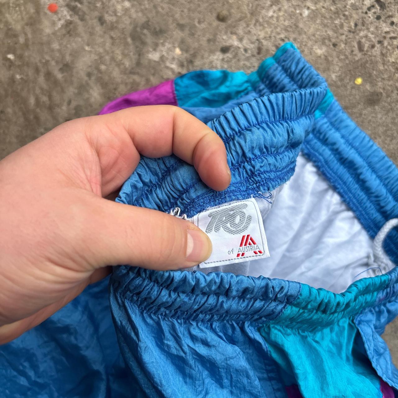 Blue vintage 80s parachute pants with elastic waist and pockets