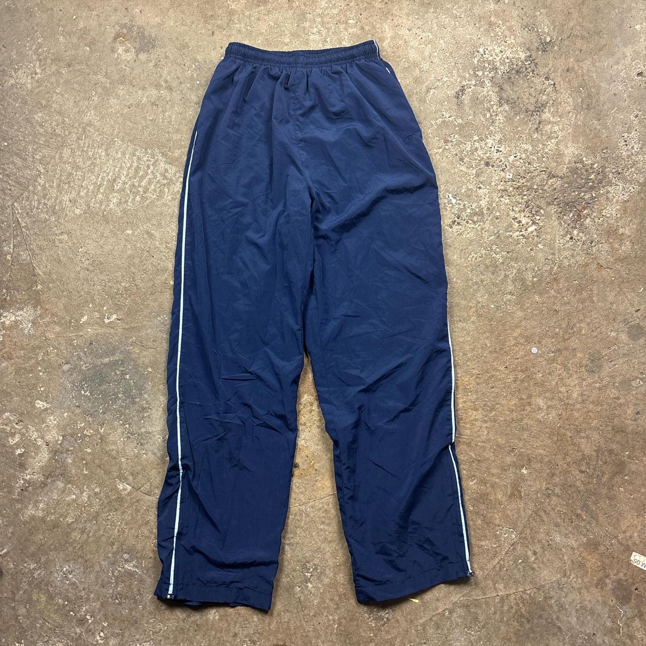 Navy Champion track pants with white stripe and embroidered logo