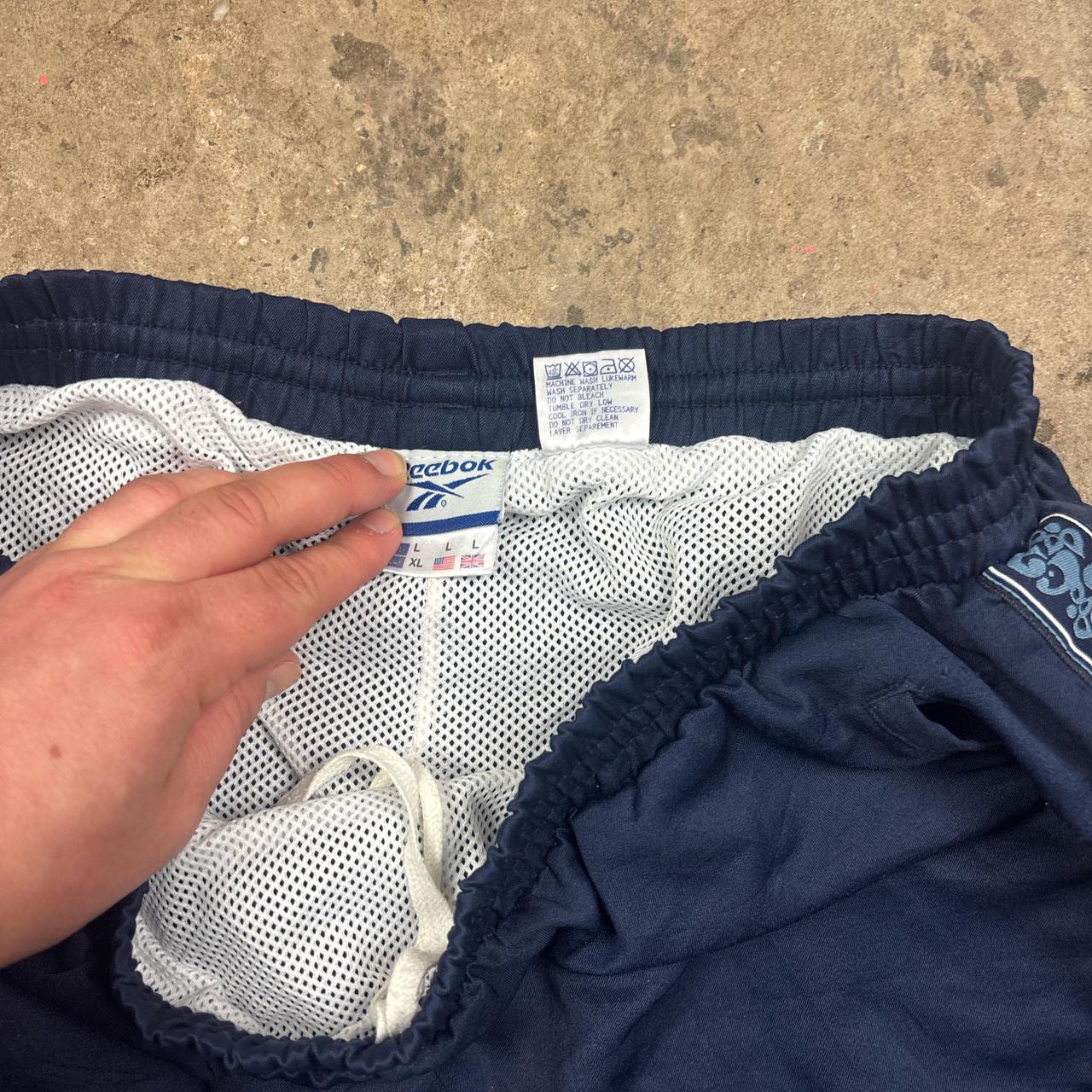 Vintage Blue Reebok track pants with embroidered logo and side stripe