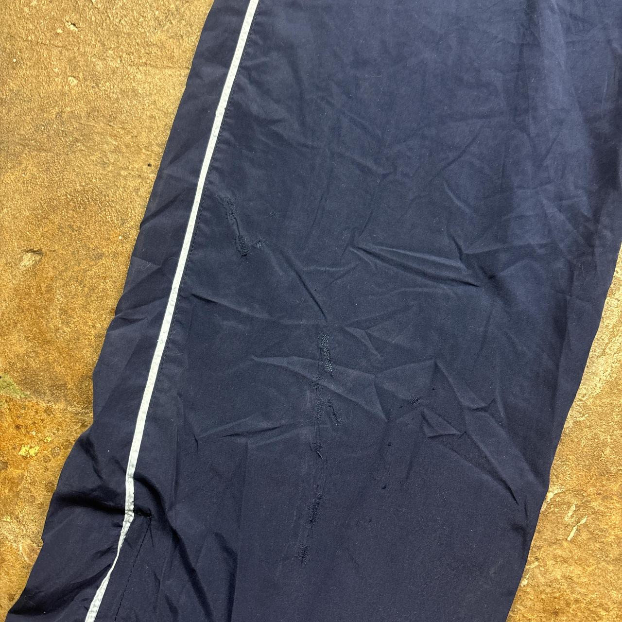 Navy Champion track pants with white stripe and embroidered logo