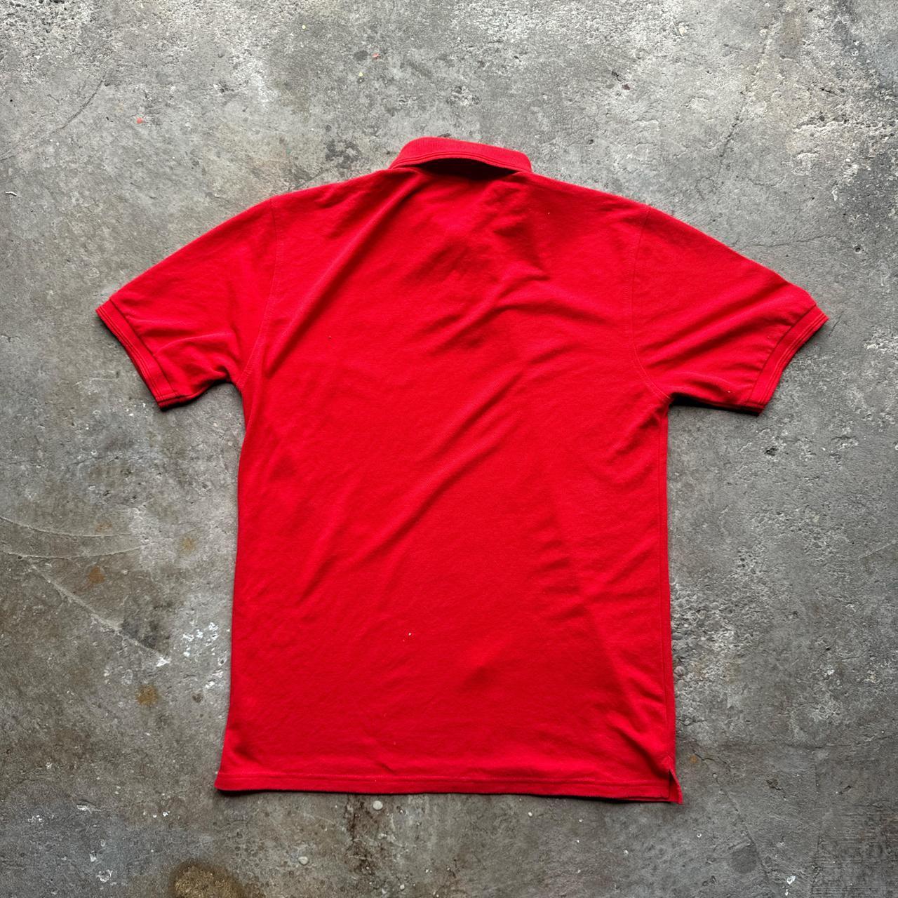 Red polo shirt with removal company embroidered design
