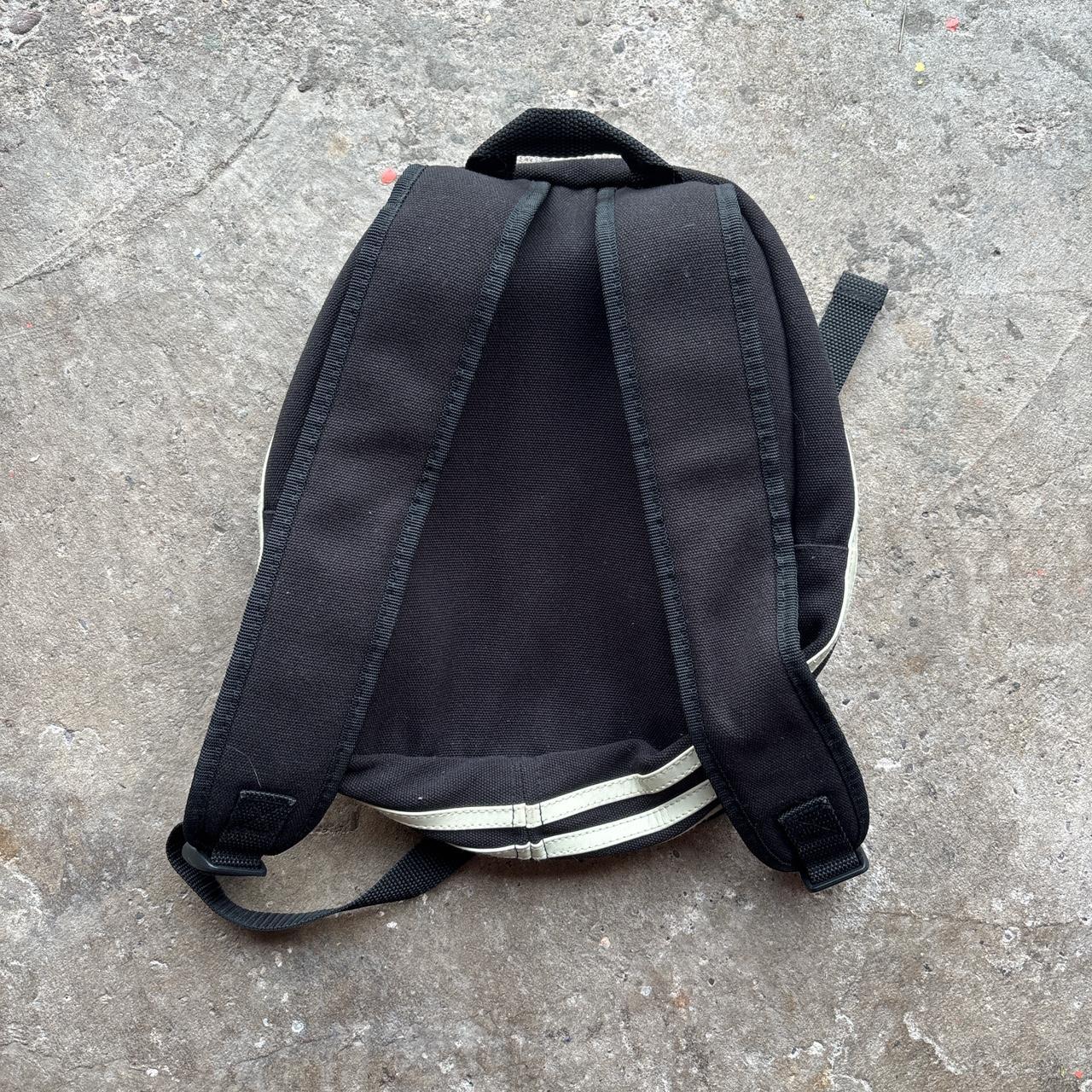Black Adidas bag with wrap around cream stripes