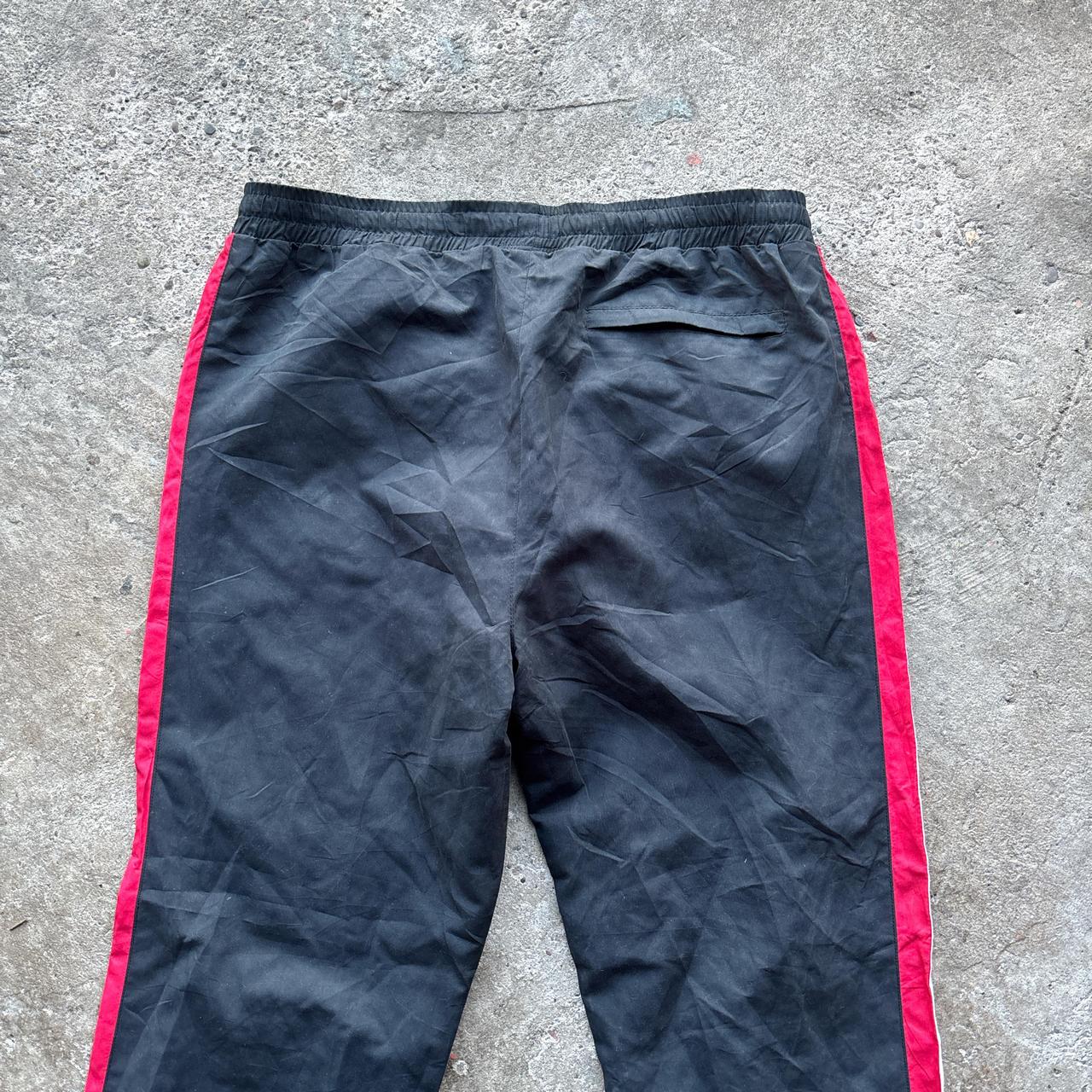 Black Nike Track pants with red and white stripes