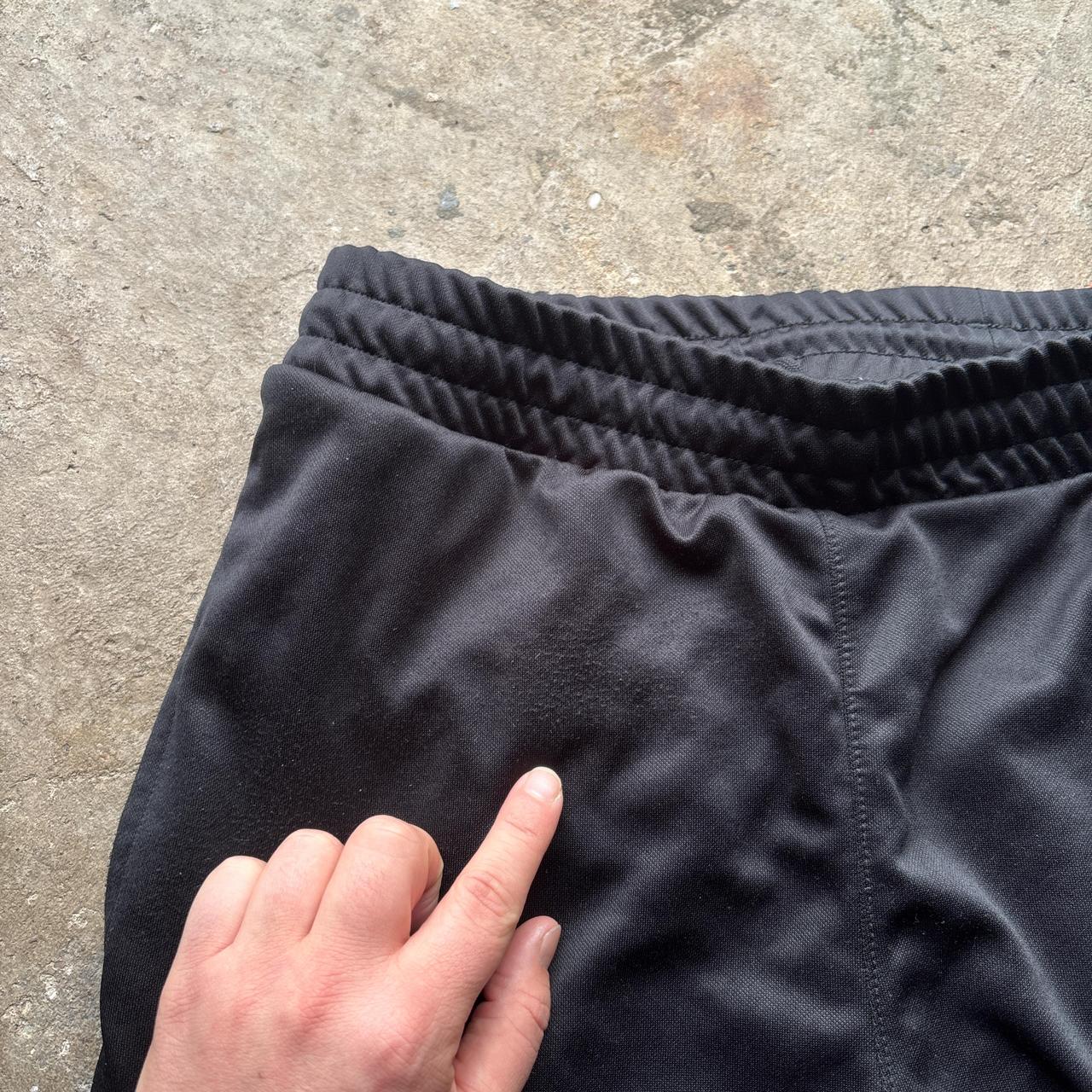 Reebok black joggers with repeat logo stripe