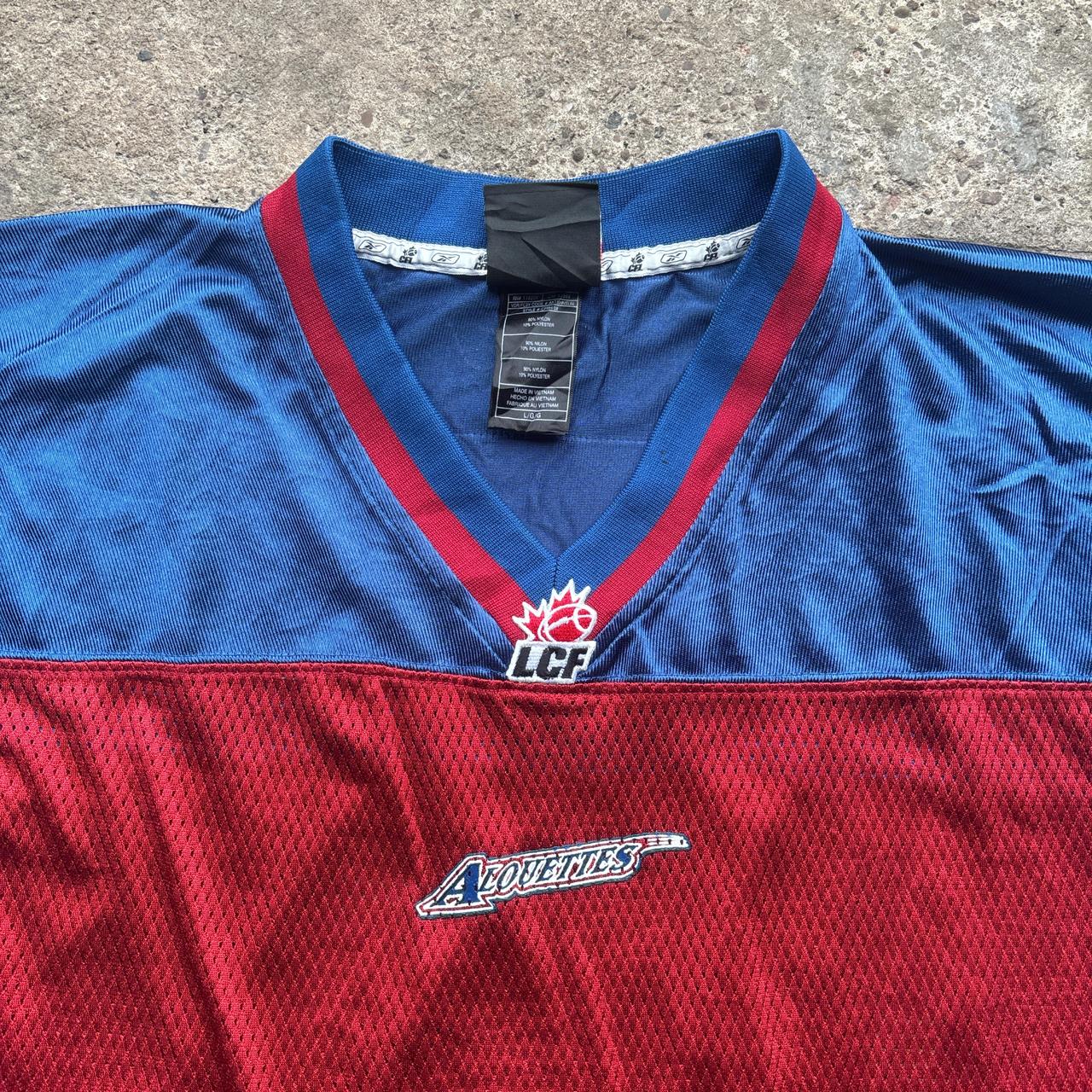 Red, blue and white Reebok CFL Alouettes jersey