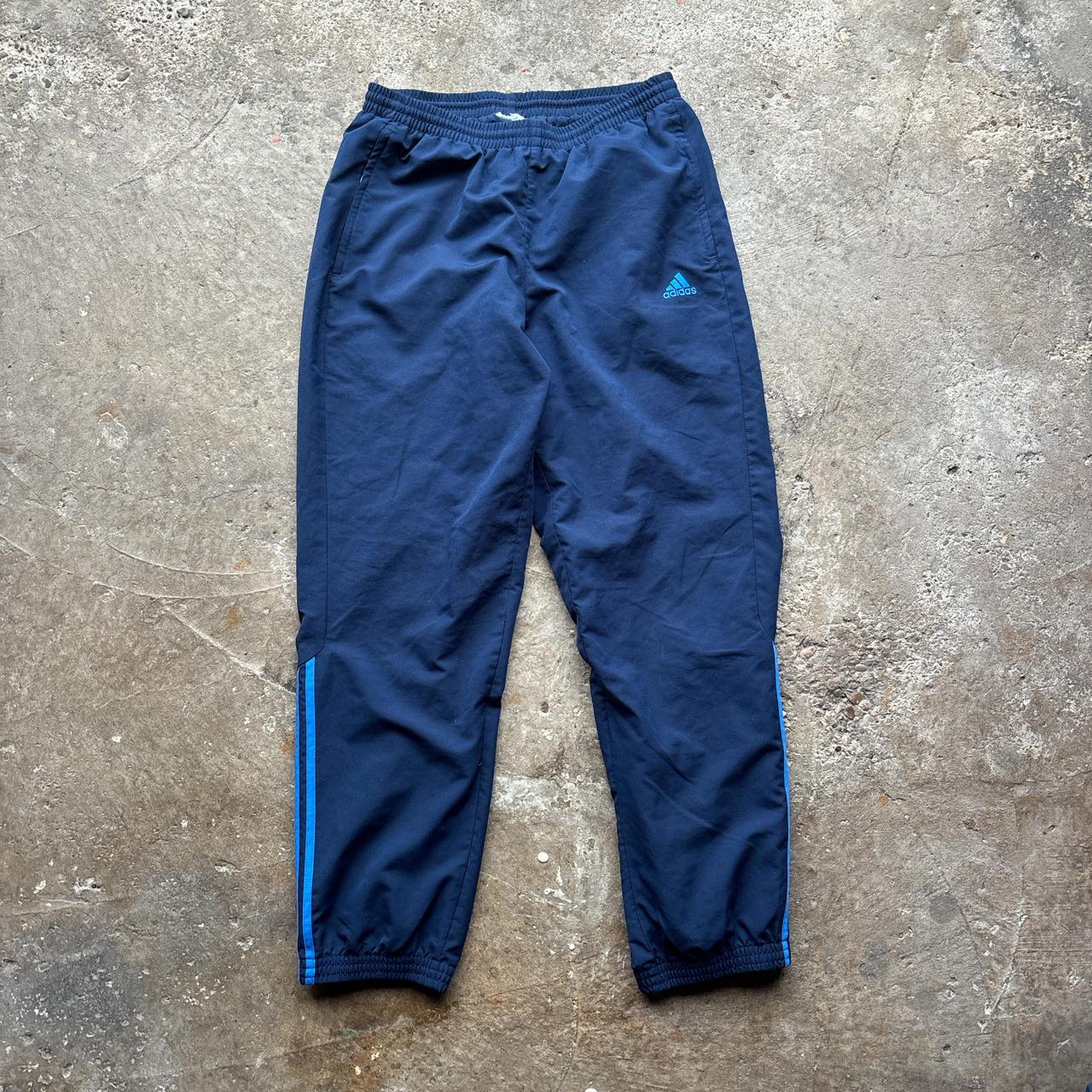 Navy Adidas track pants with blue stripes and embroidered logo
