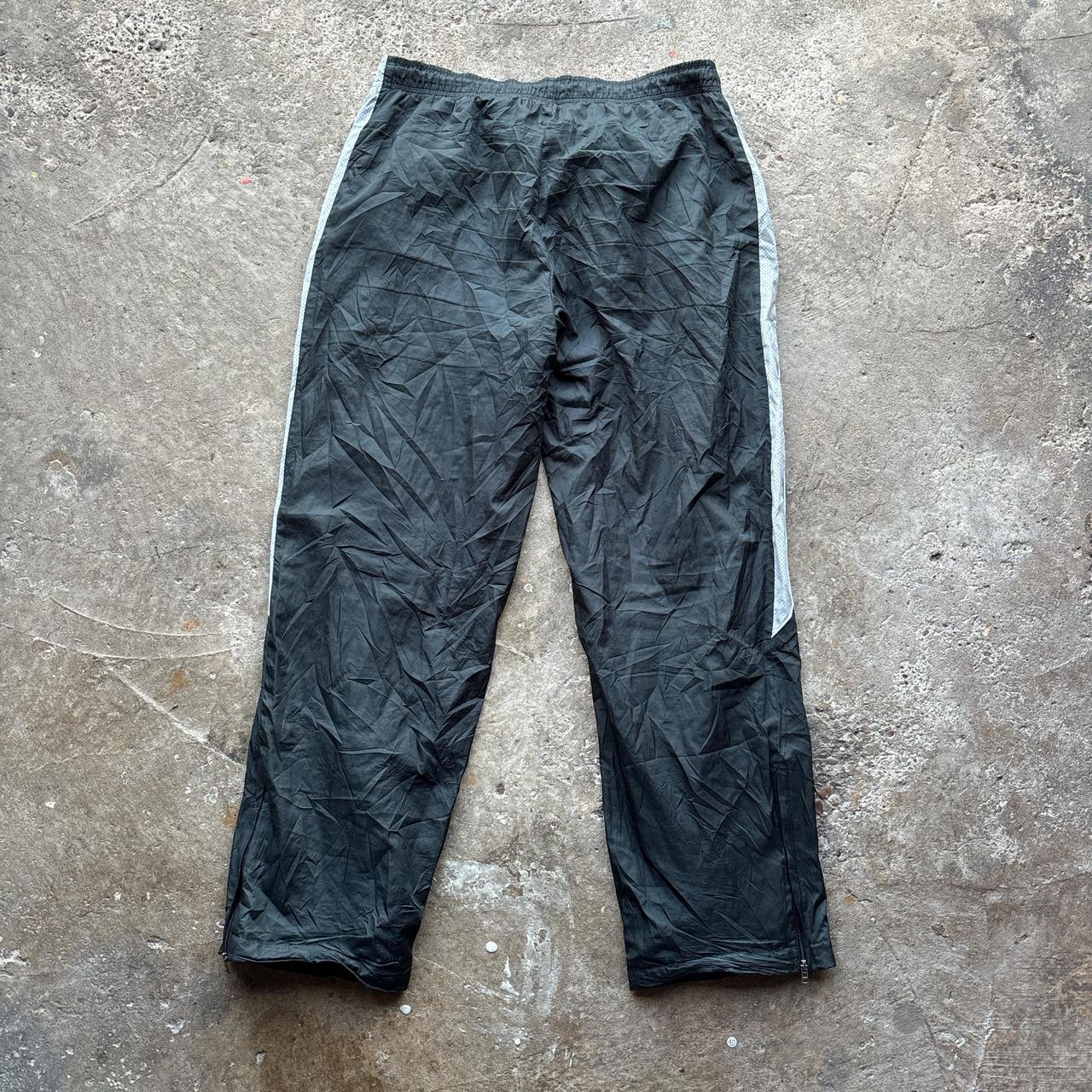 Black 00s Nike track pants with grey side stripe