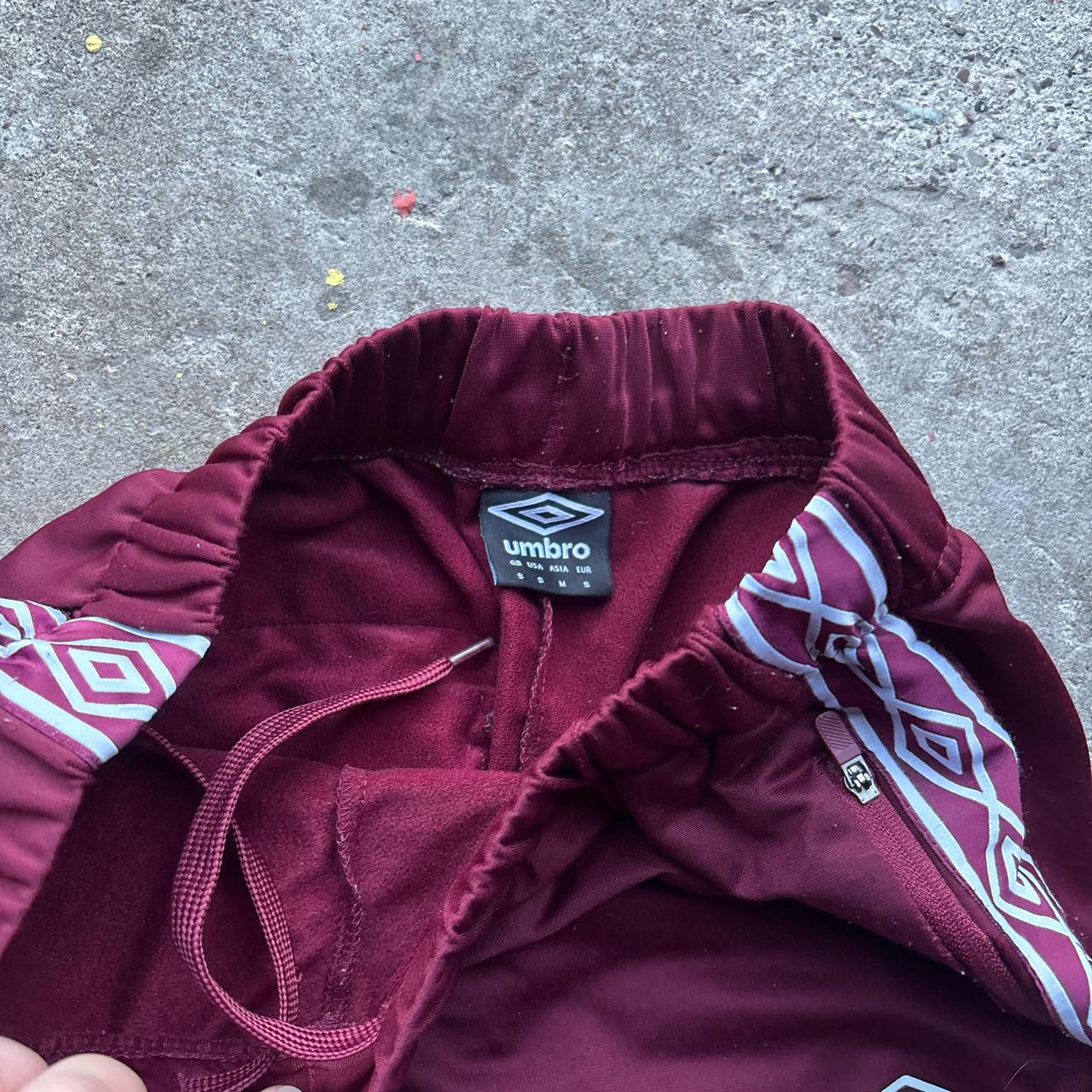 Burgundy Umbro sweatpants with stripe down the leg