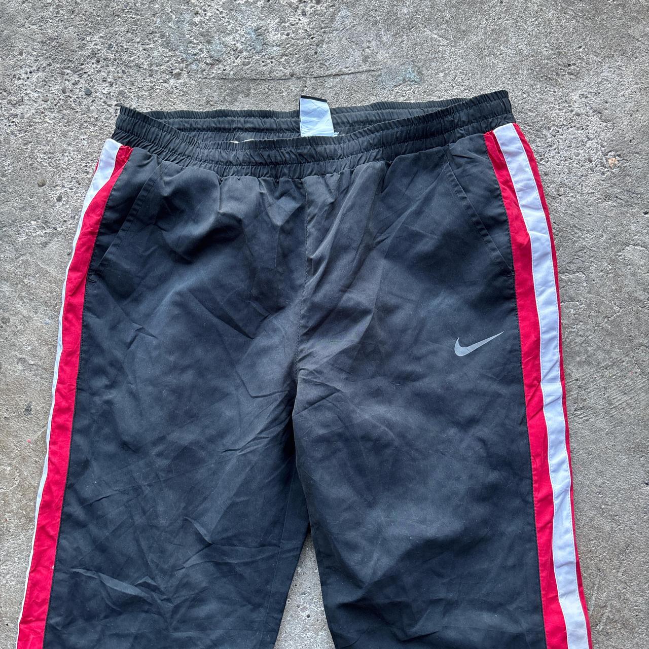 Black Nike Track pants with red and white stripes
