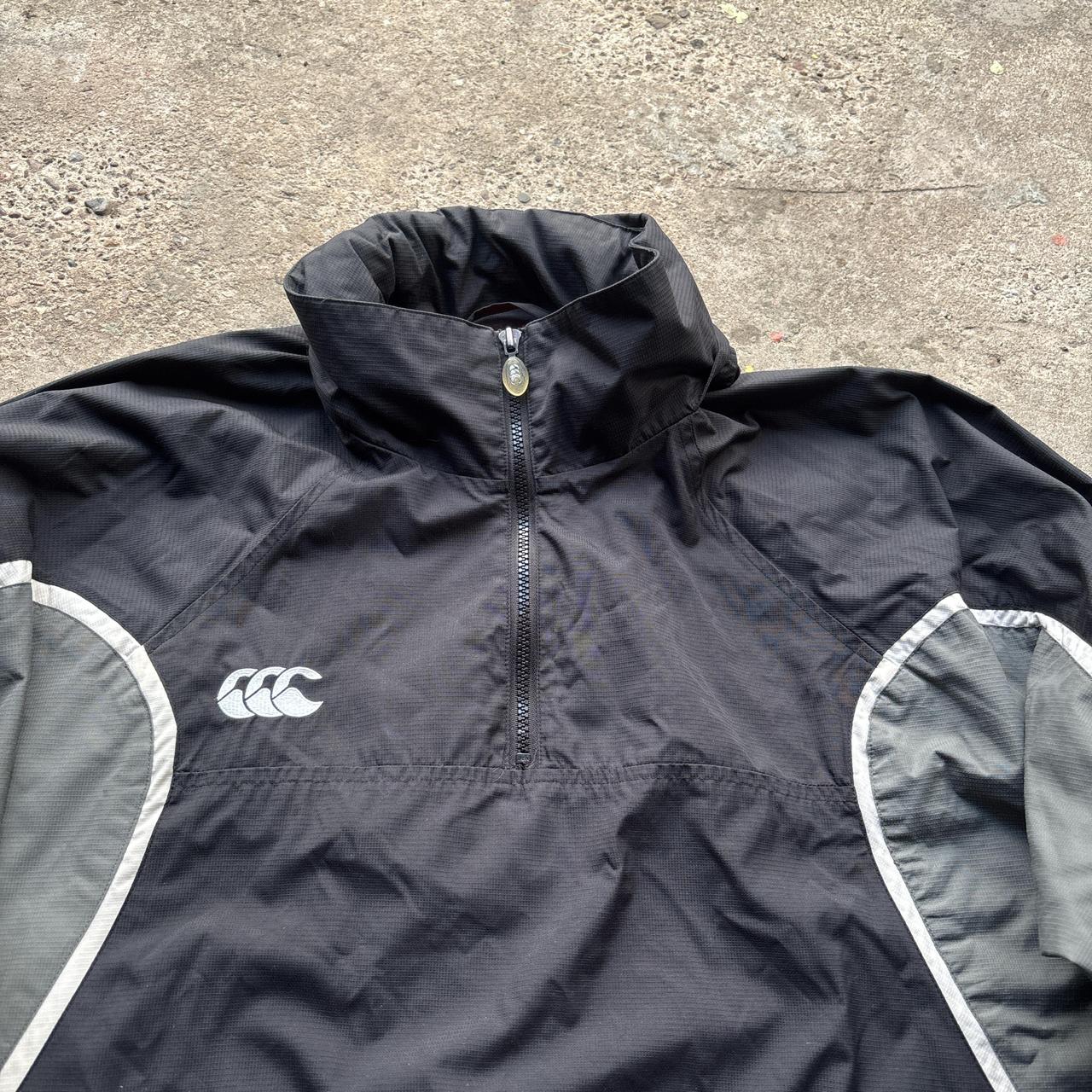 Black and grey Canterbury quarter zip windbreaker