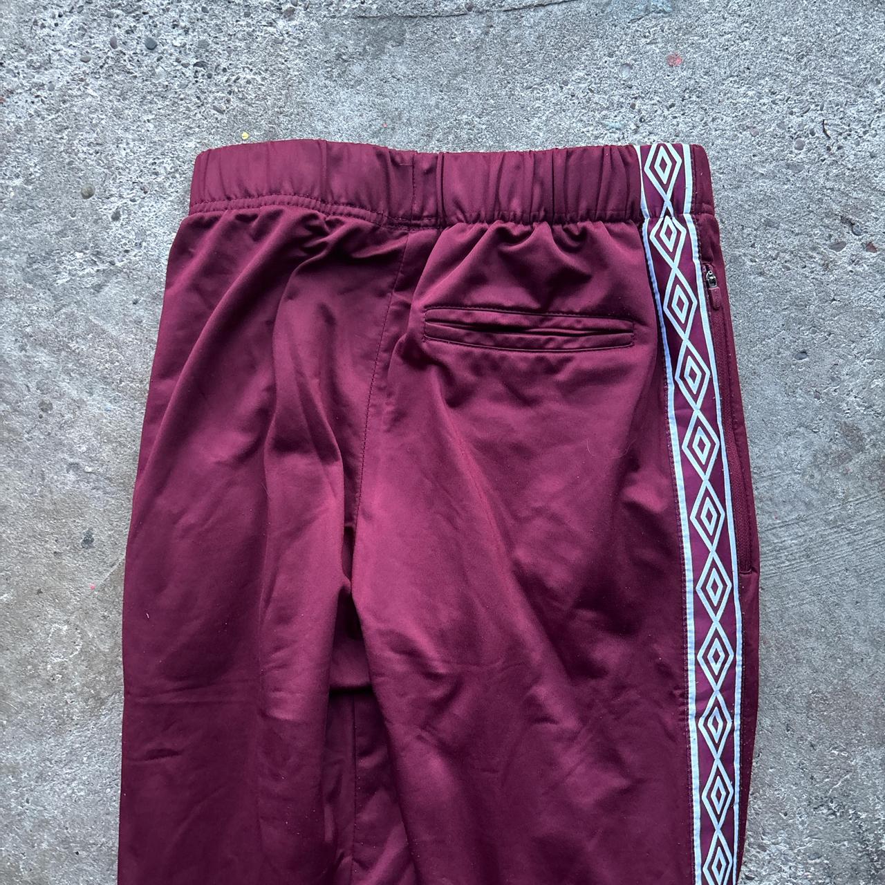 Burgundy Umbro sweatpants with stripe down the leg