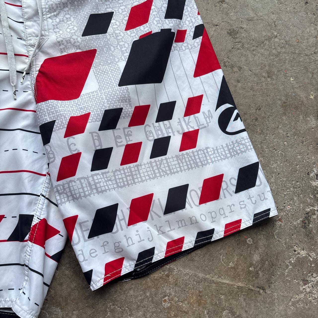 White, red and black 00s Quicksilver Dane Reynolds Board Shorts