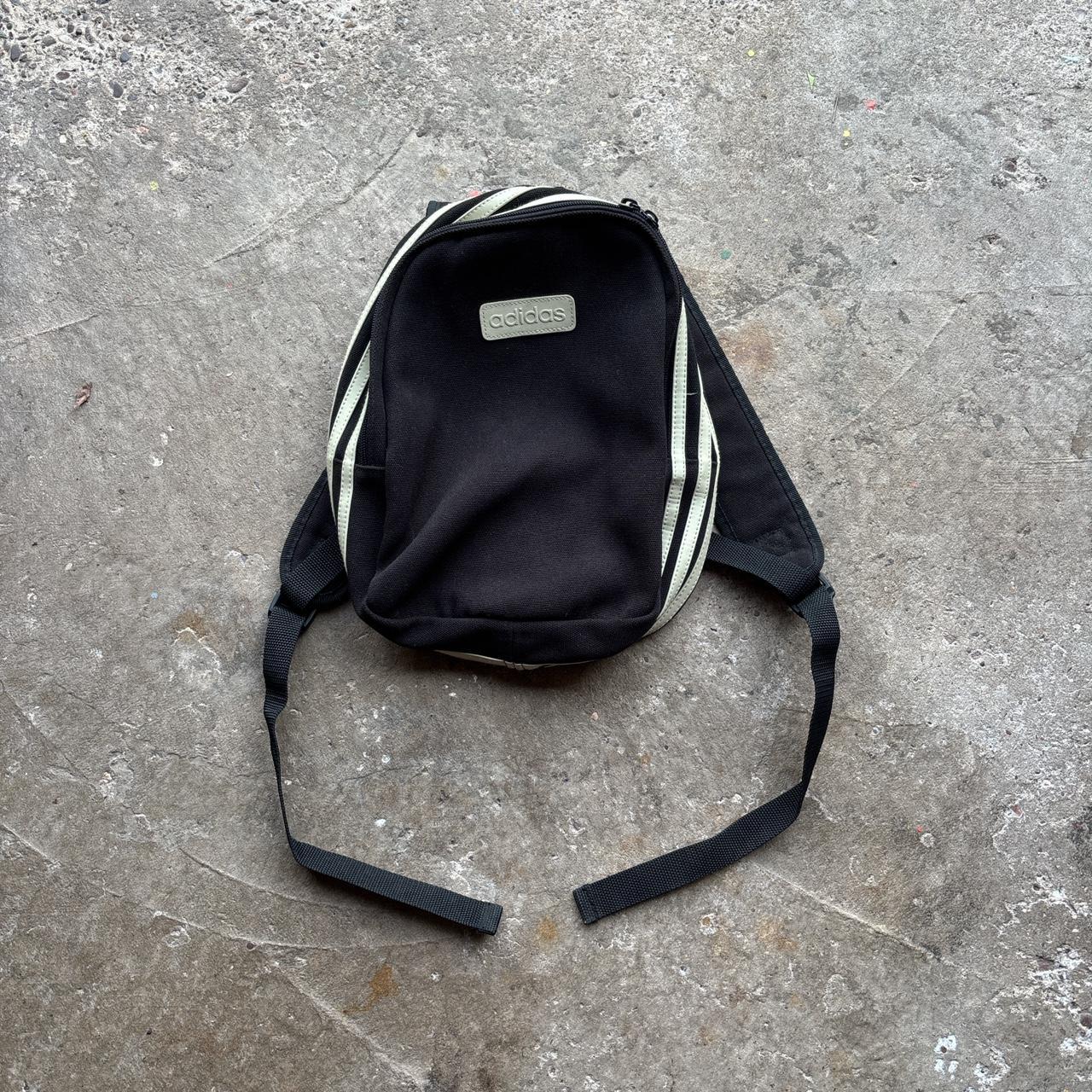 Black Adidas bag with wrap around cream stripes