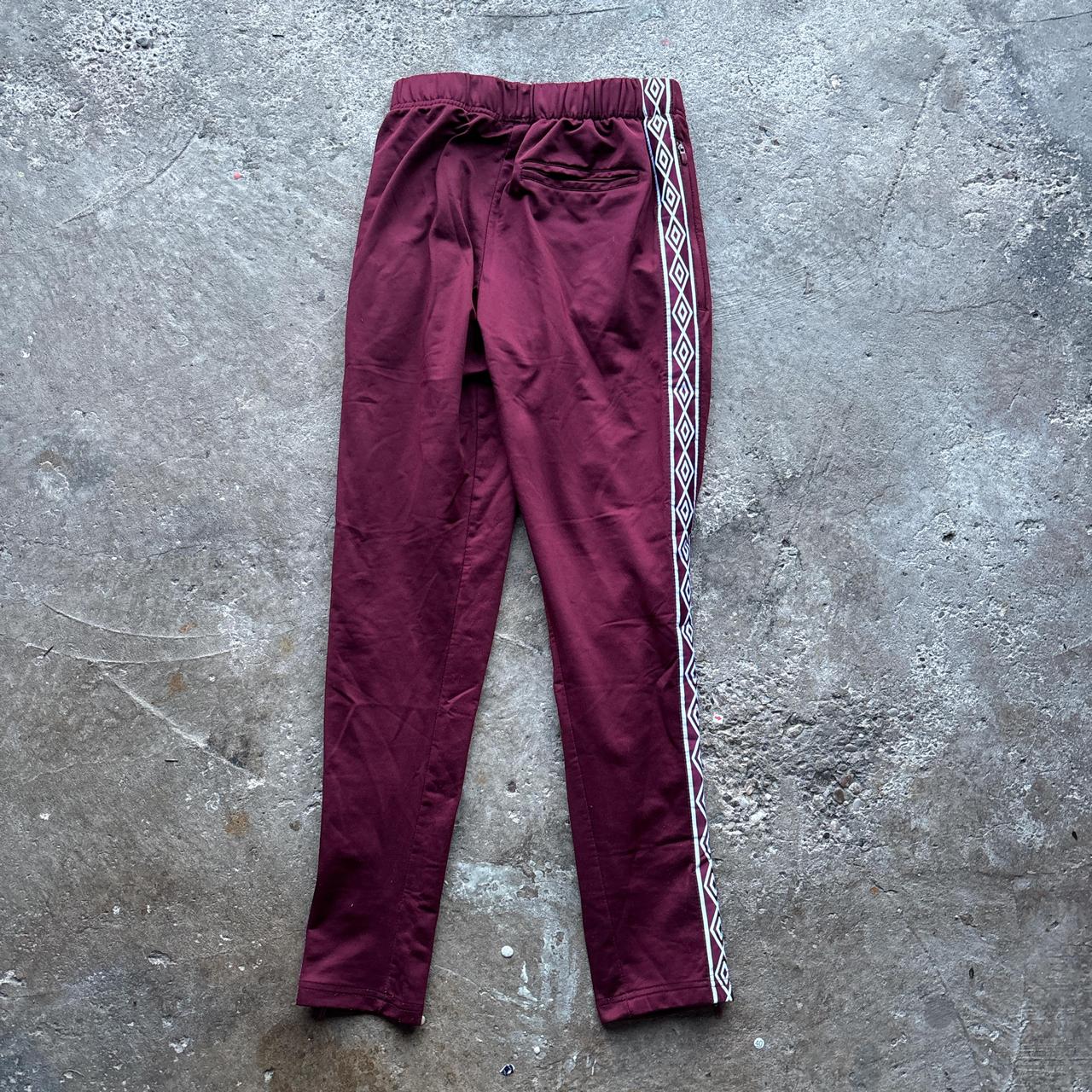 Burgundy Umbro sweatpants with stripe down the leg