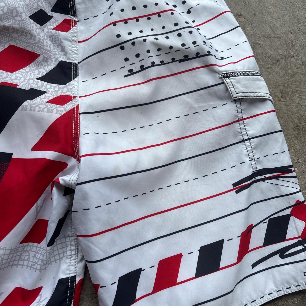 White, red and black 00s Quicksilver Dane Reynolds Board Shorts