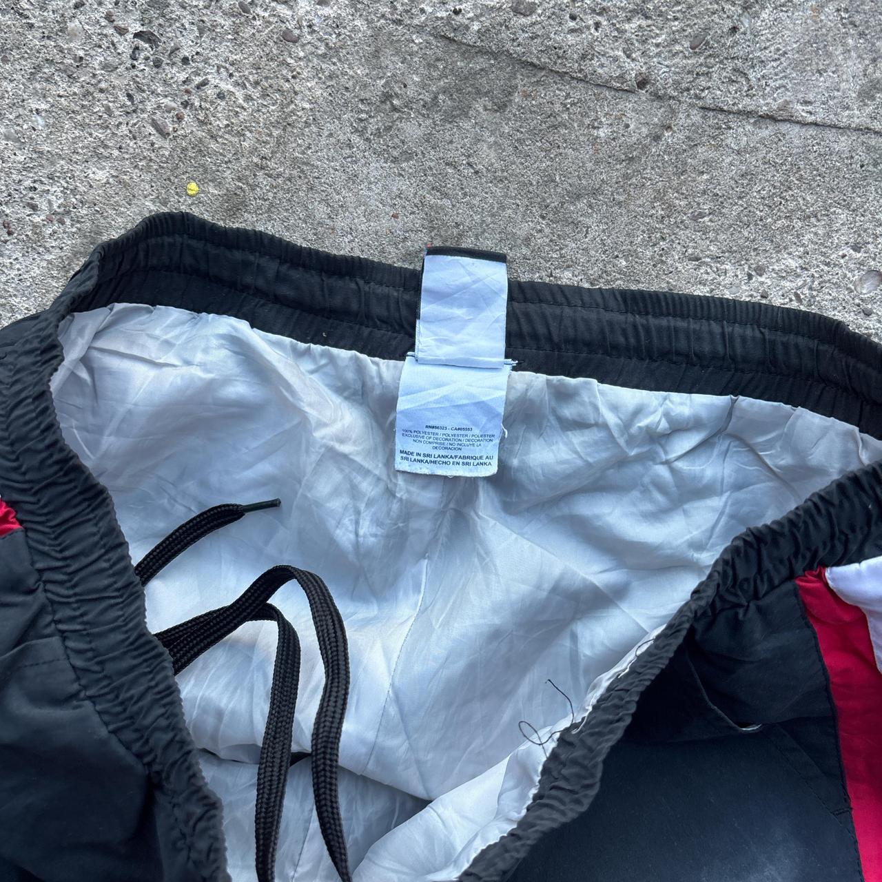 Black Nike Track pants with red and white stripes
