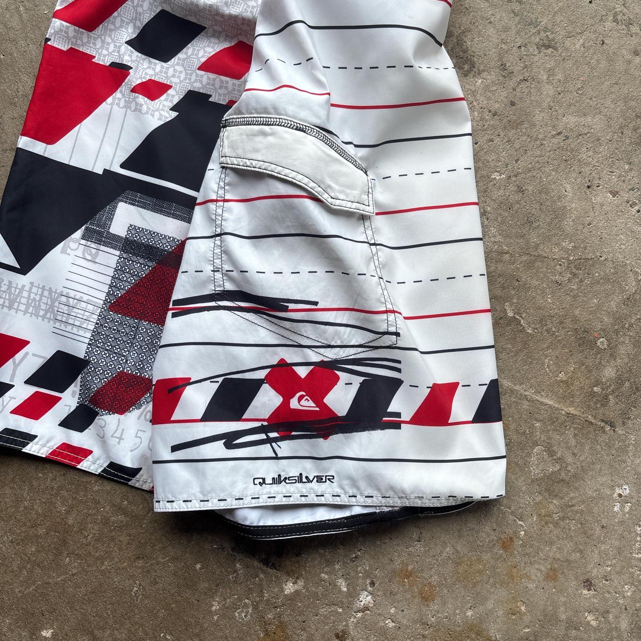 White, red and black 00s Quicksilver Dane Reynolds Board Shorts