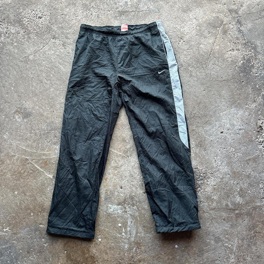 Black 00s Nike track pants with grey side stripe